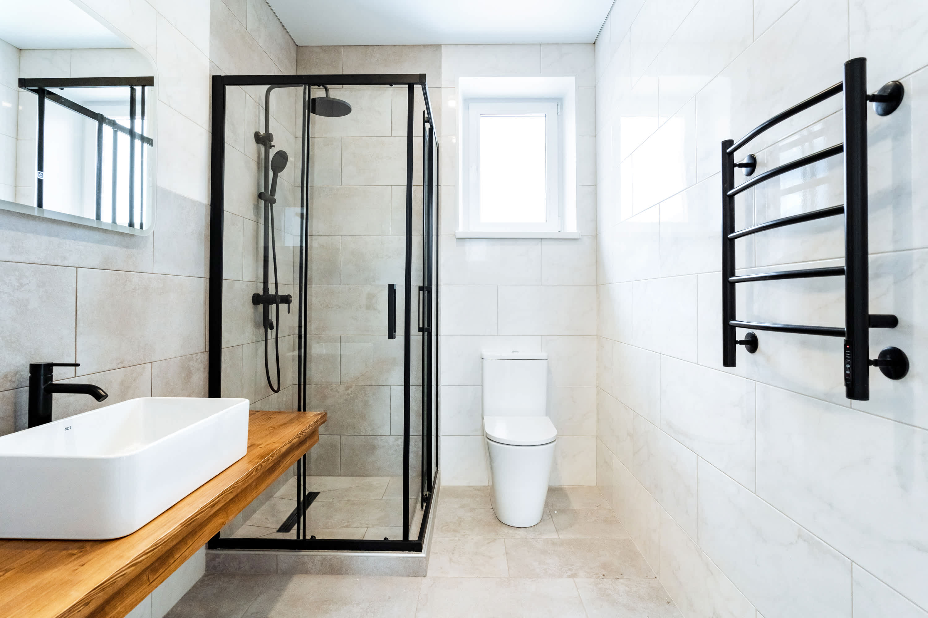 New bathroom with double vanities and walk-in shower