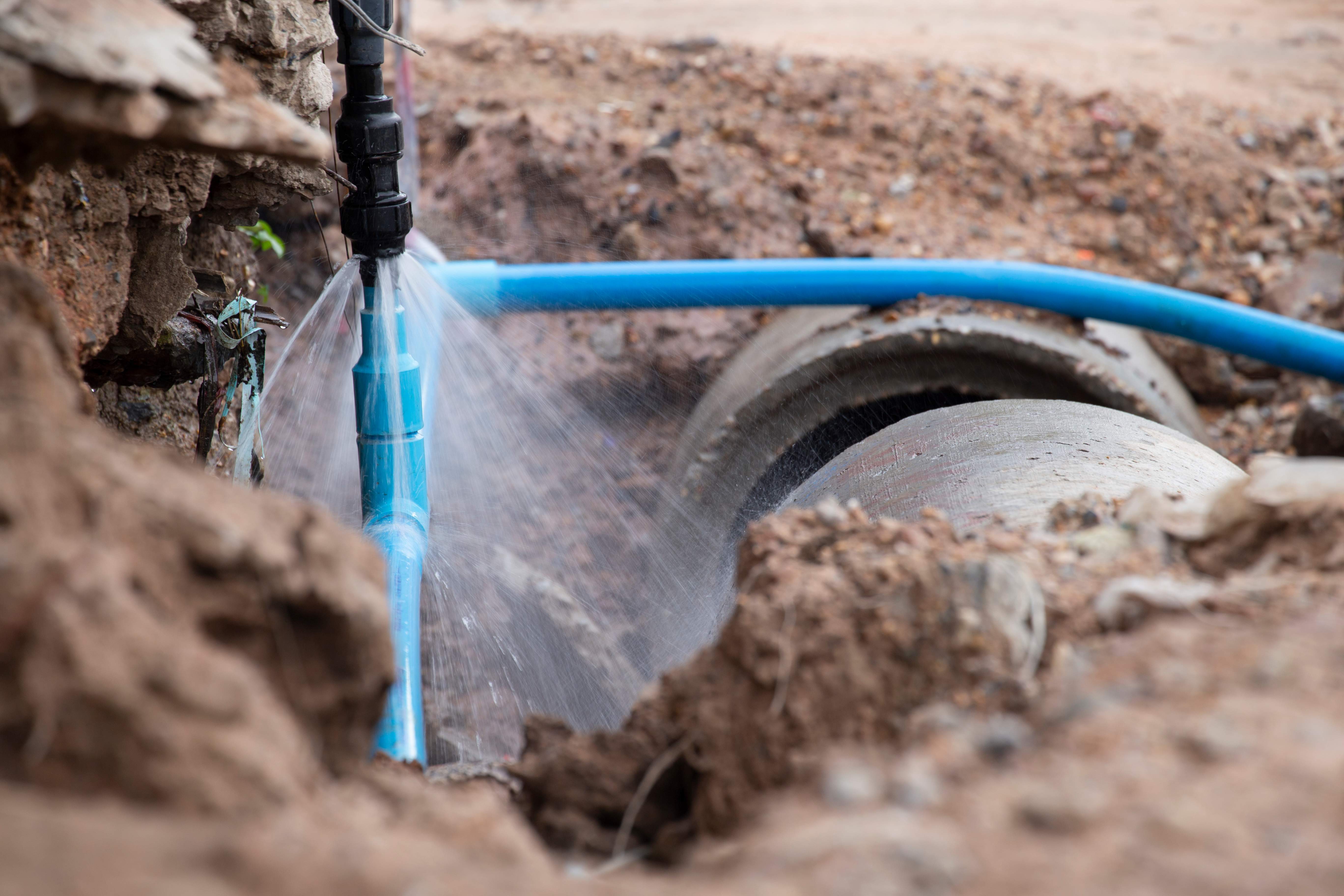 A broken water pipe is spraying water