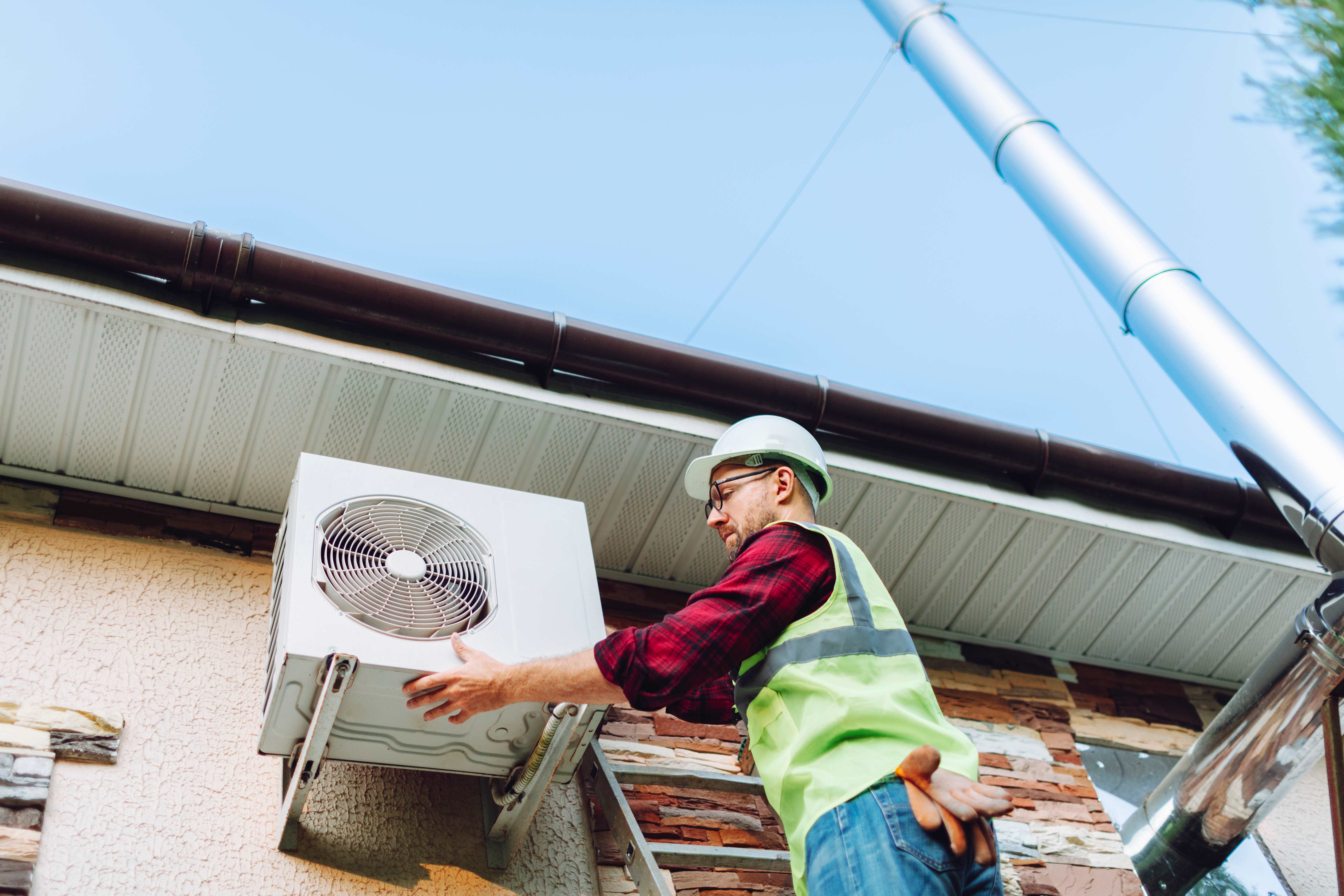technician replacing ac