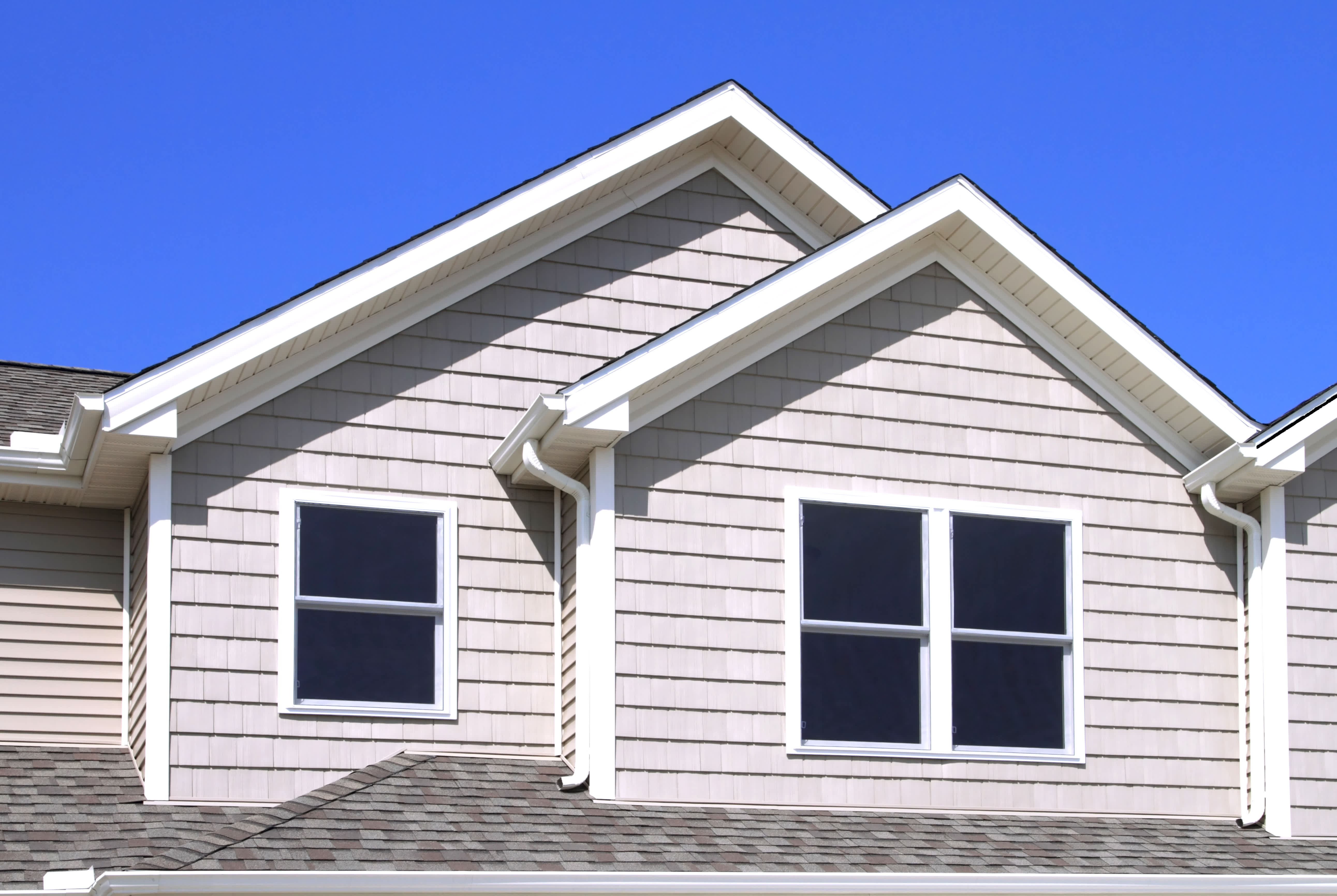 Vinyl shake siding installed on a two-story house