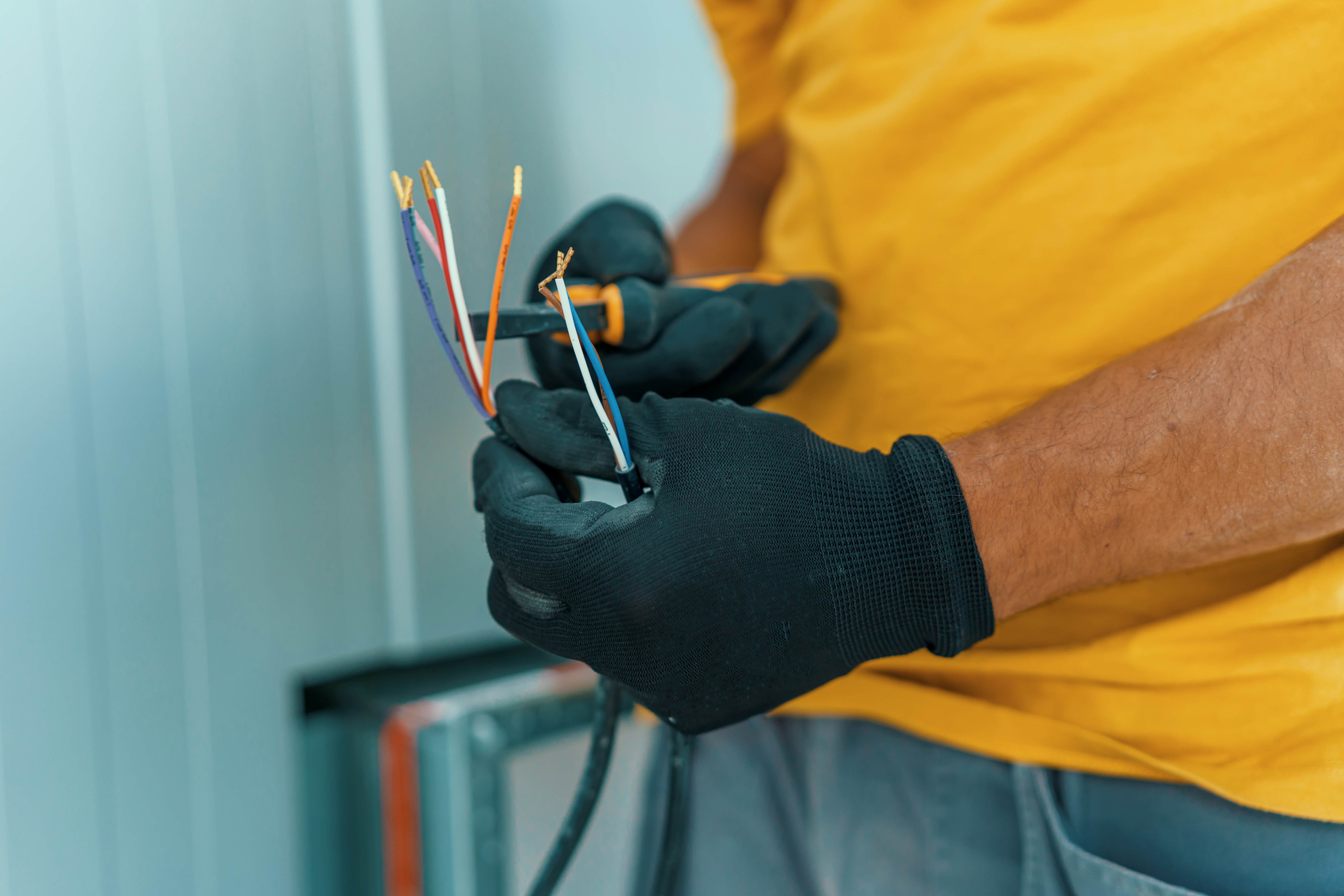 Electrician holding an electric cable