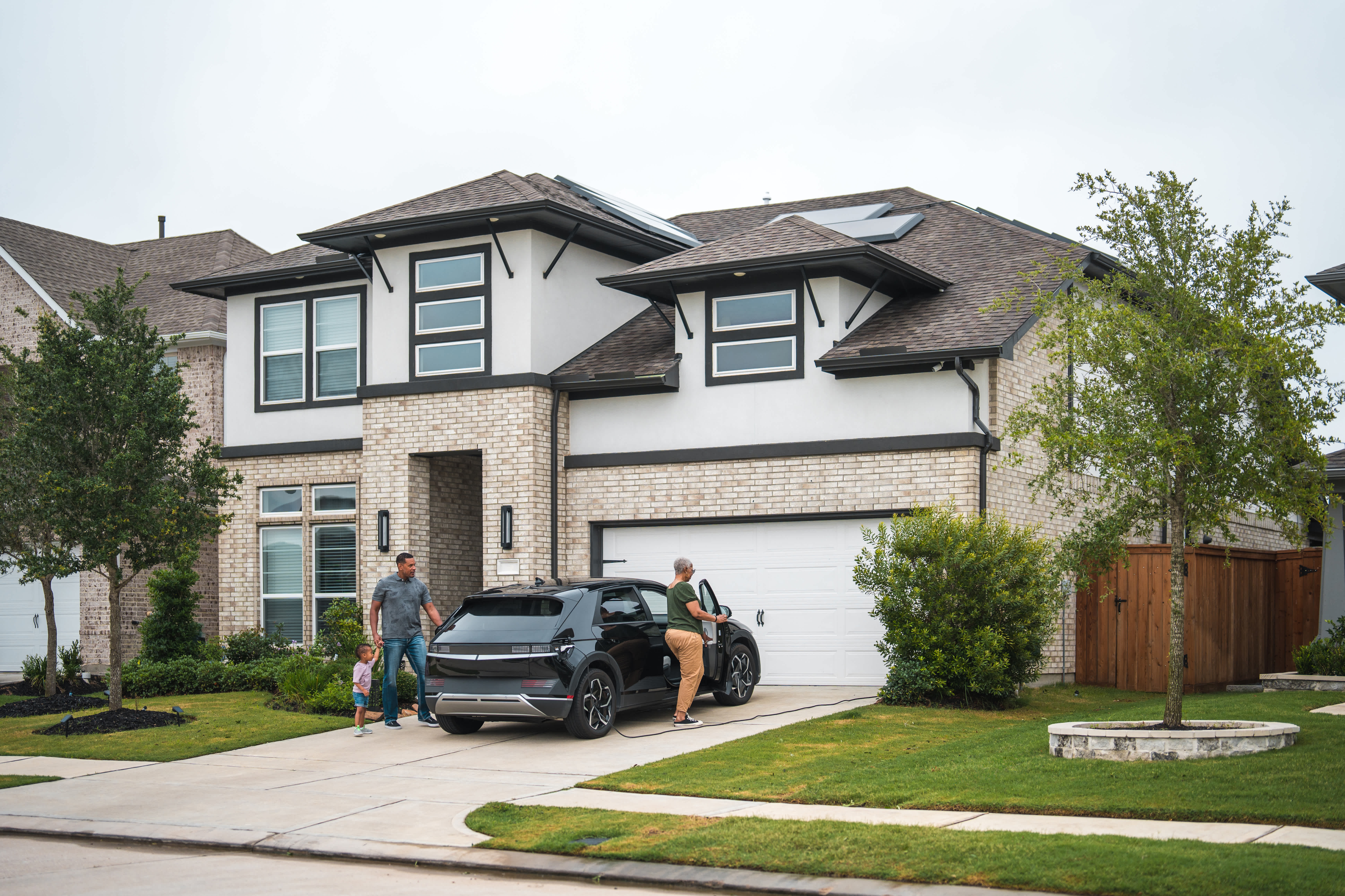 Family in front of a modern home