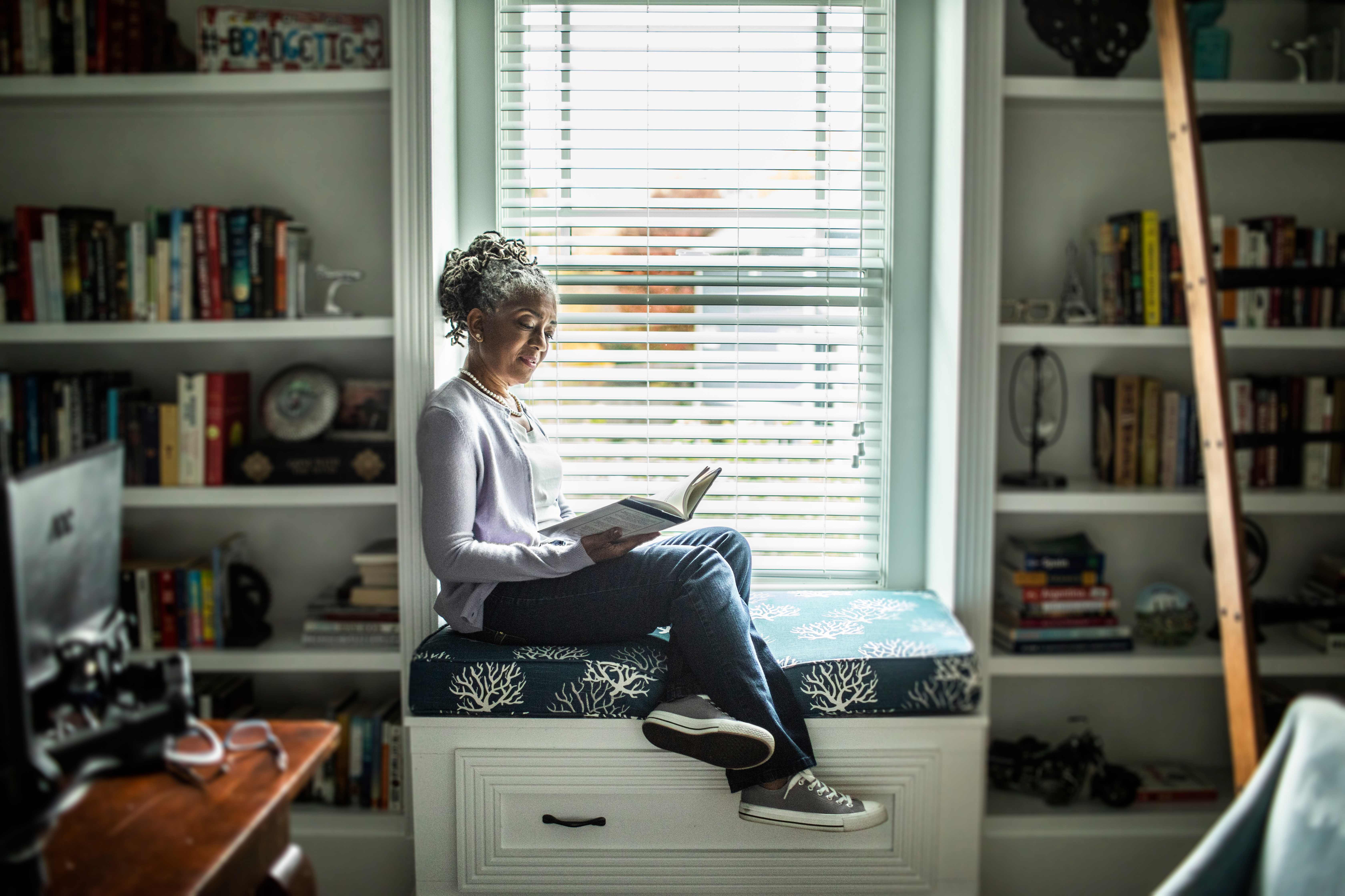 Woman reading in home library