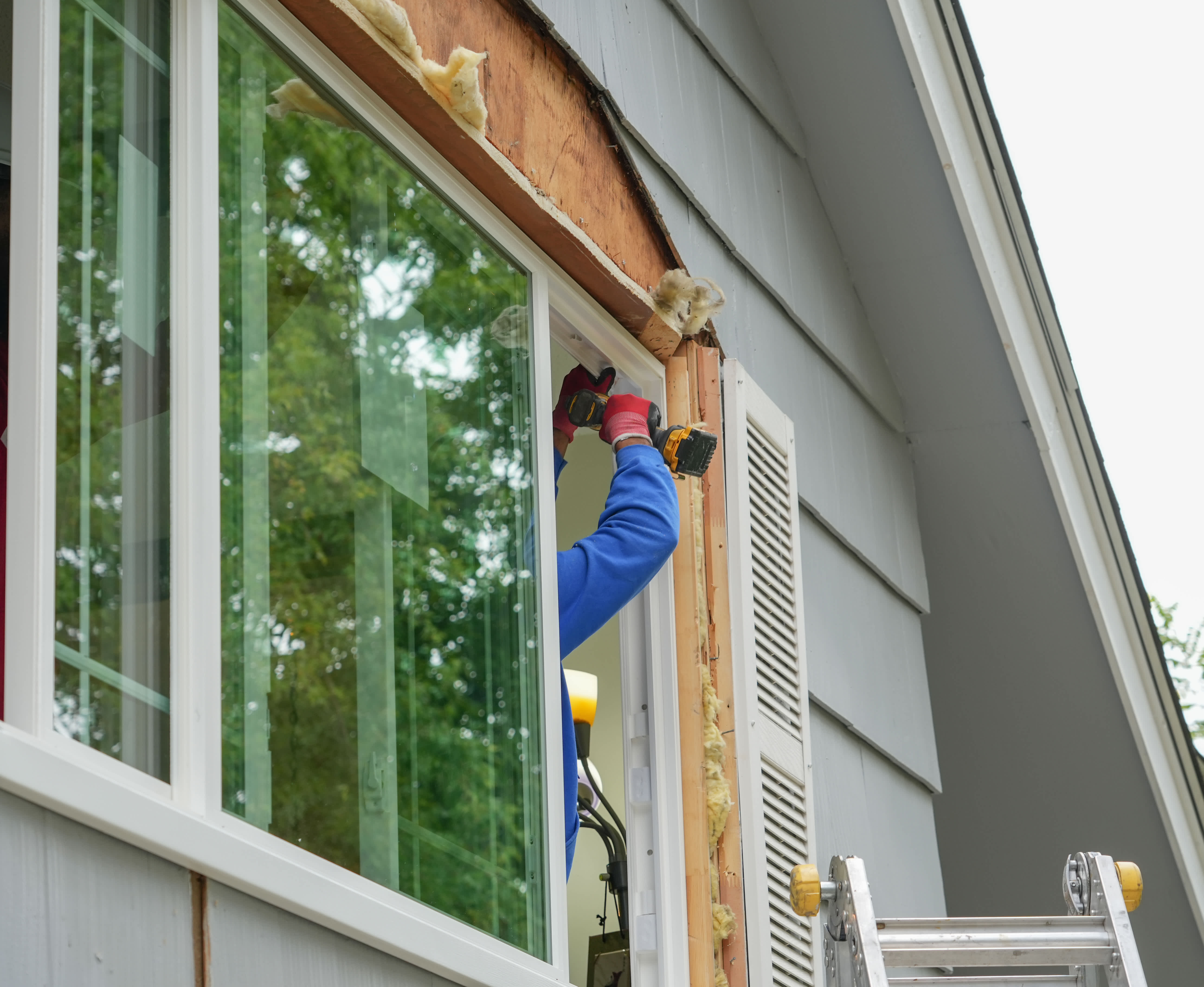 A professional installing a new window