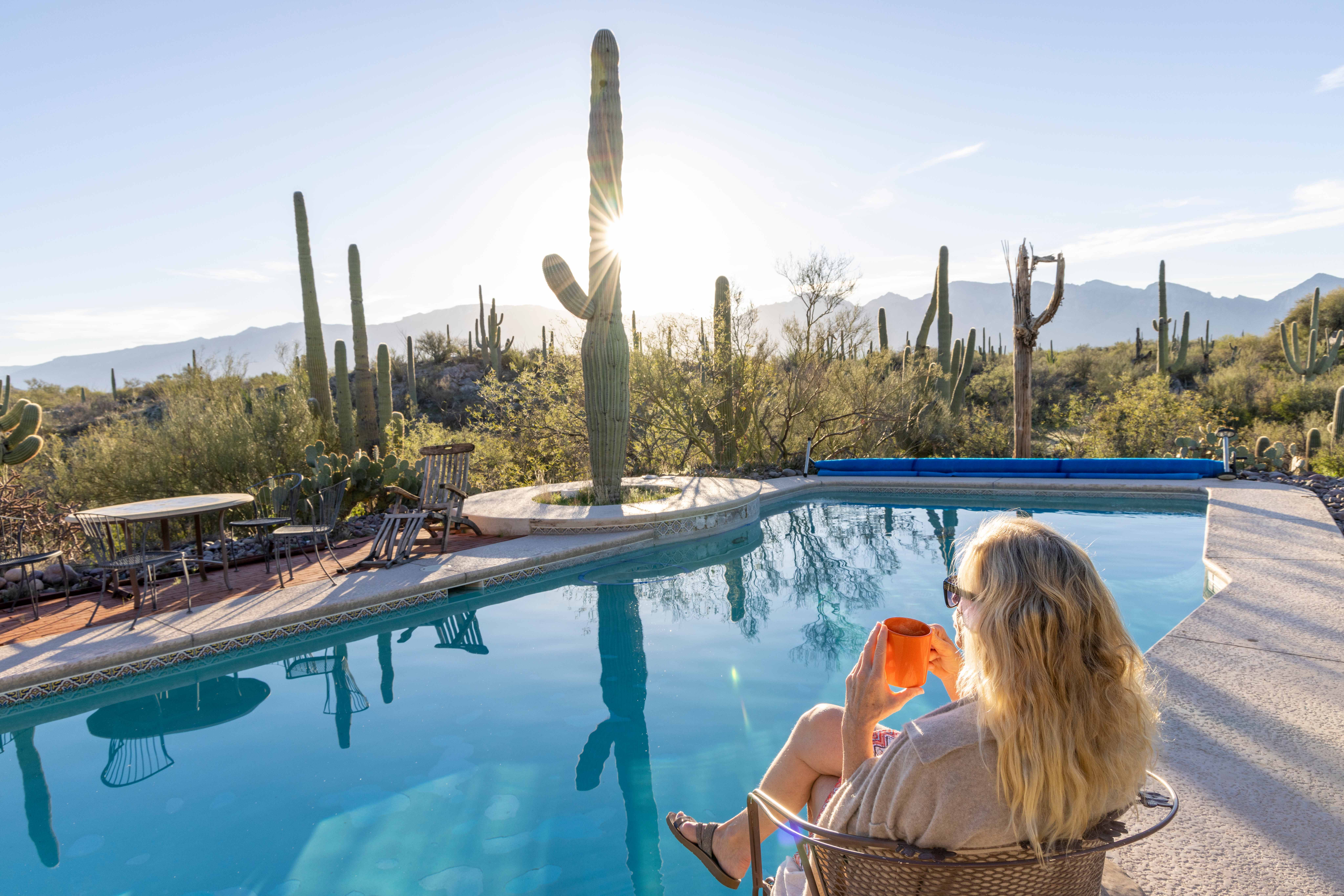 Woman sitting by pool in Phoenix
