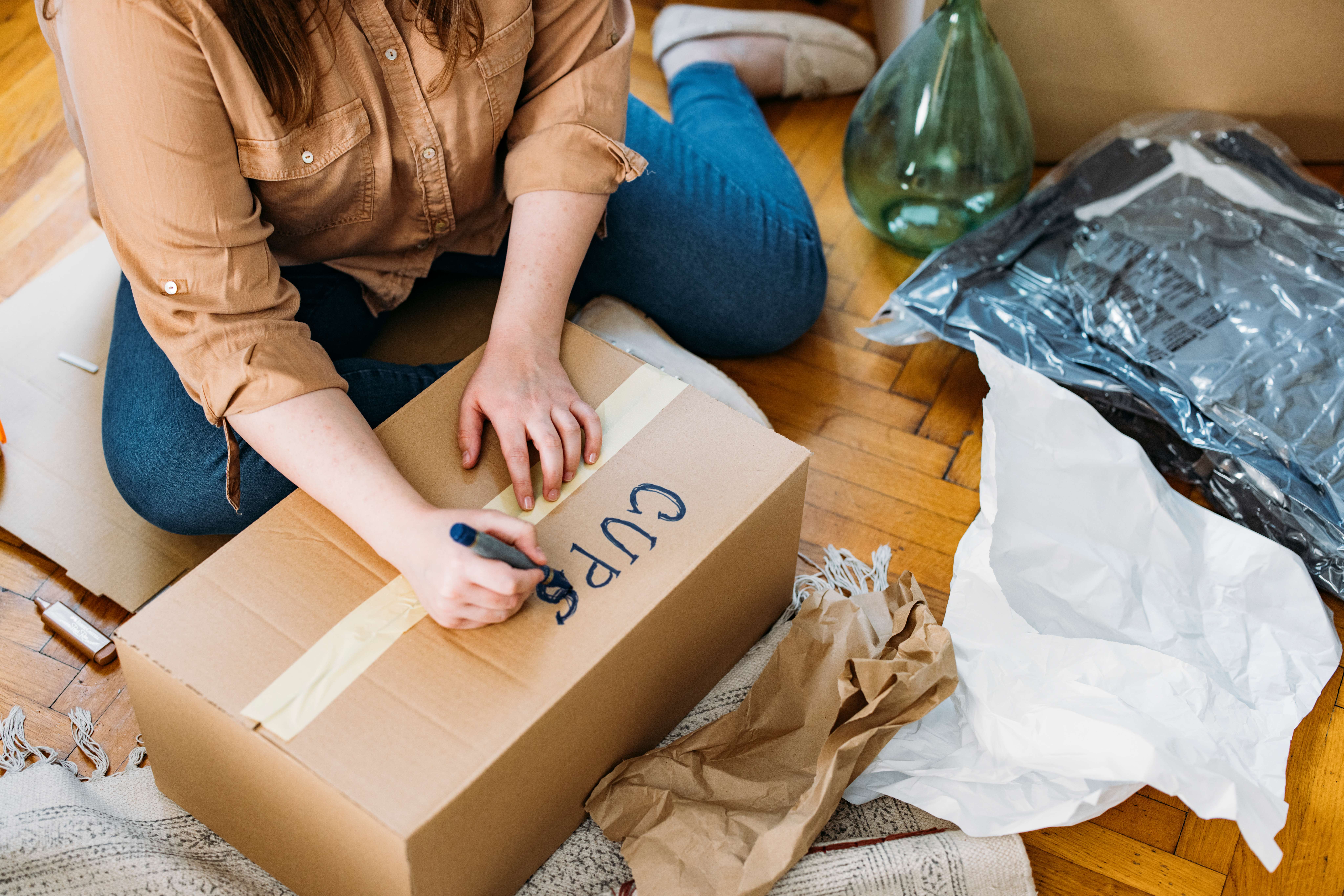 woman labeling moving box