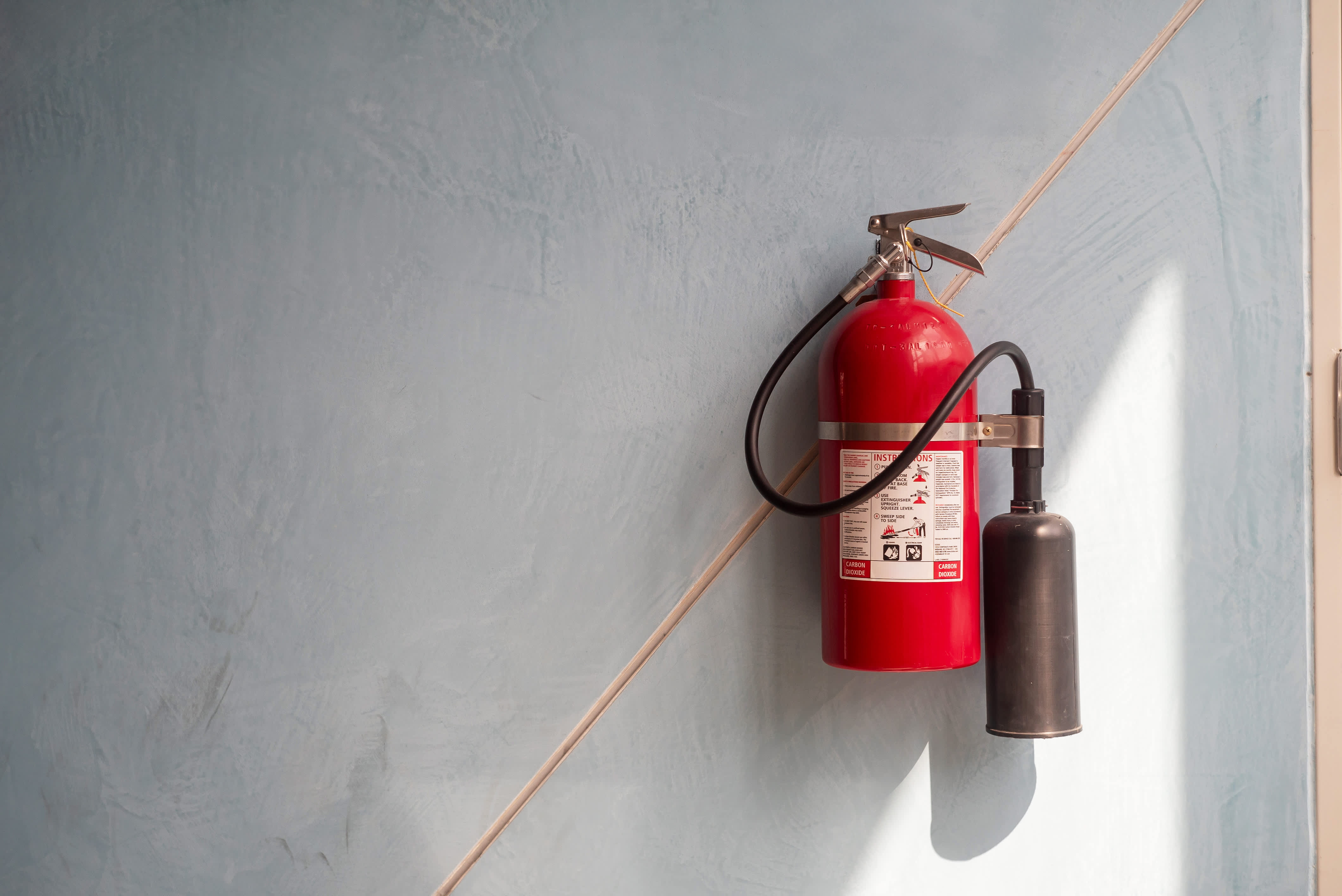 Fire extinguisher mounted on wall