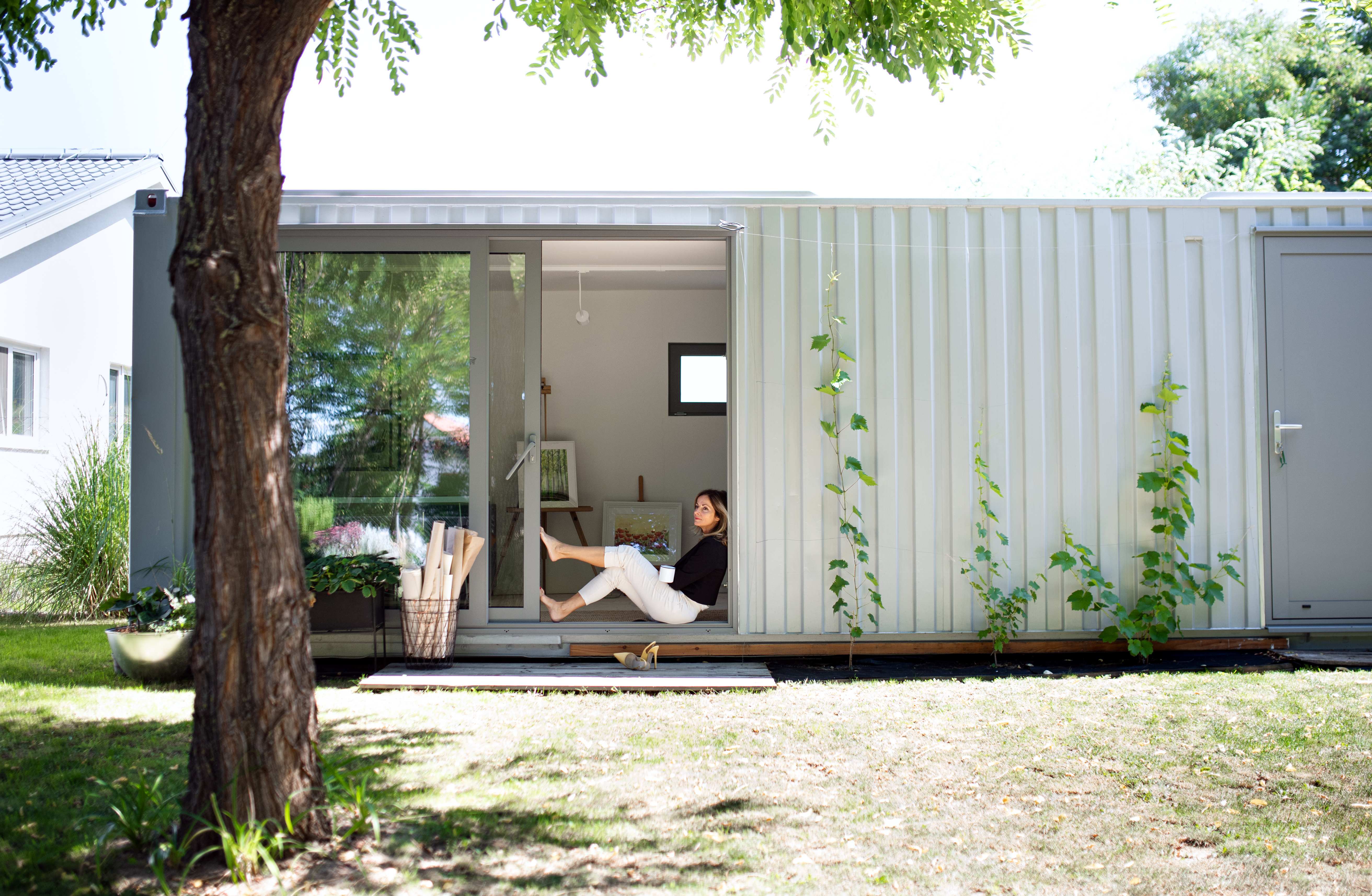 Woman sitting outside container home