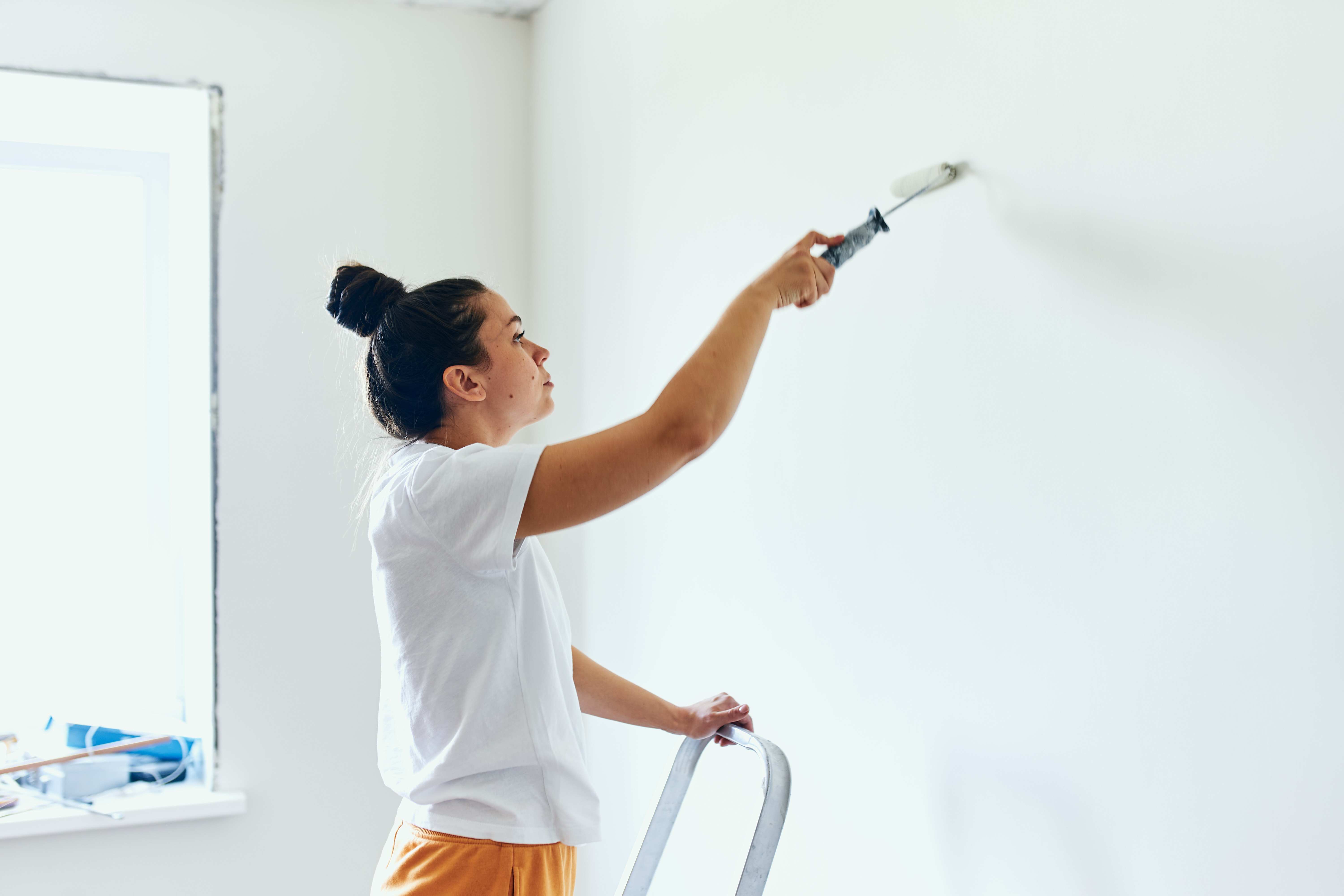Woman painting wall