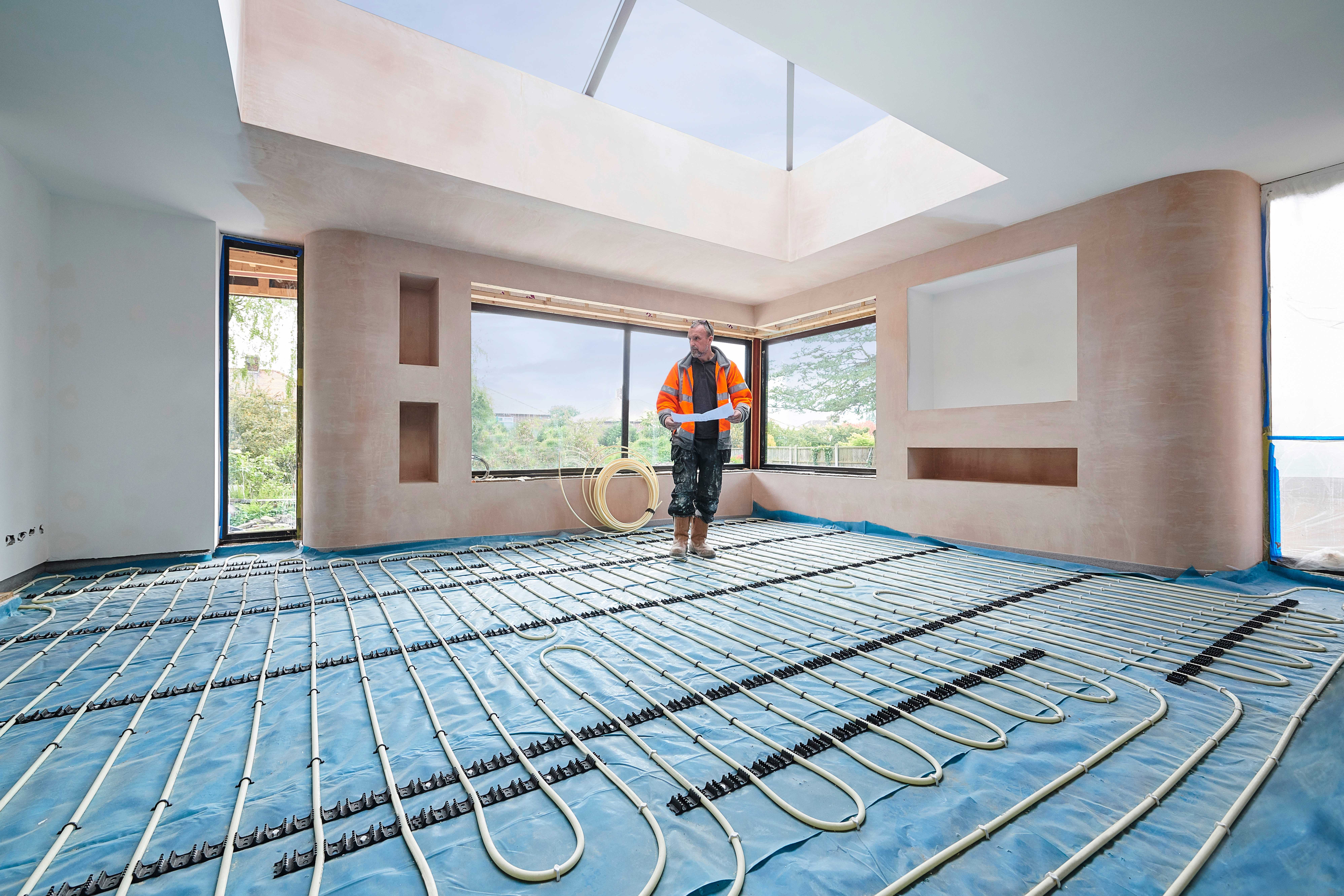 A professional installing radiant floor heating