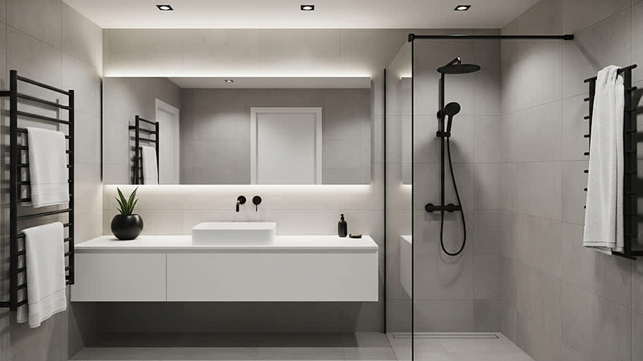 A modern, gray-tiled bathroom with a glass shower, a floating vanity, and matte black hardware.