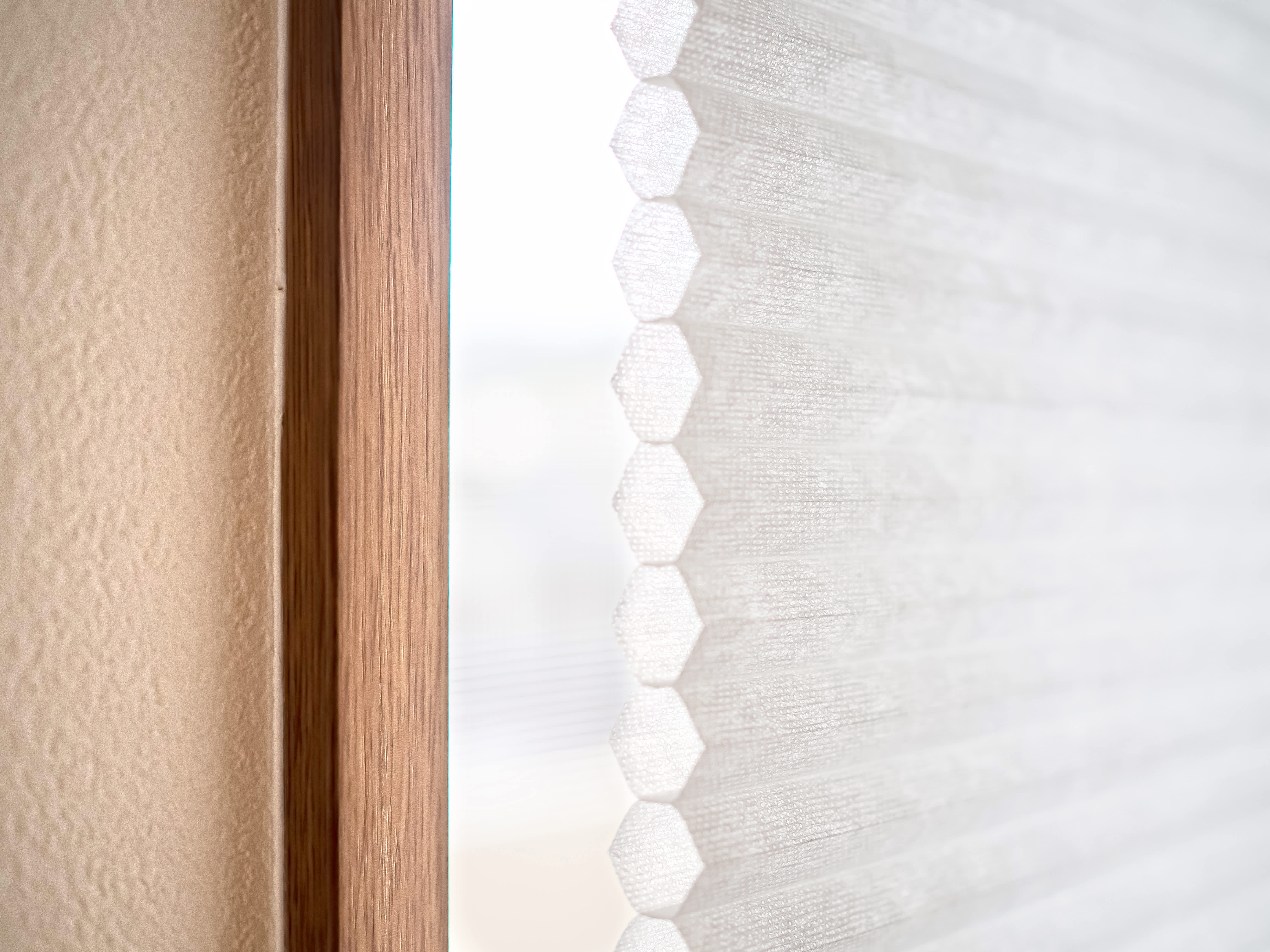 Close-up of a window with a single cellular shade