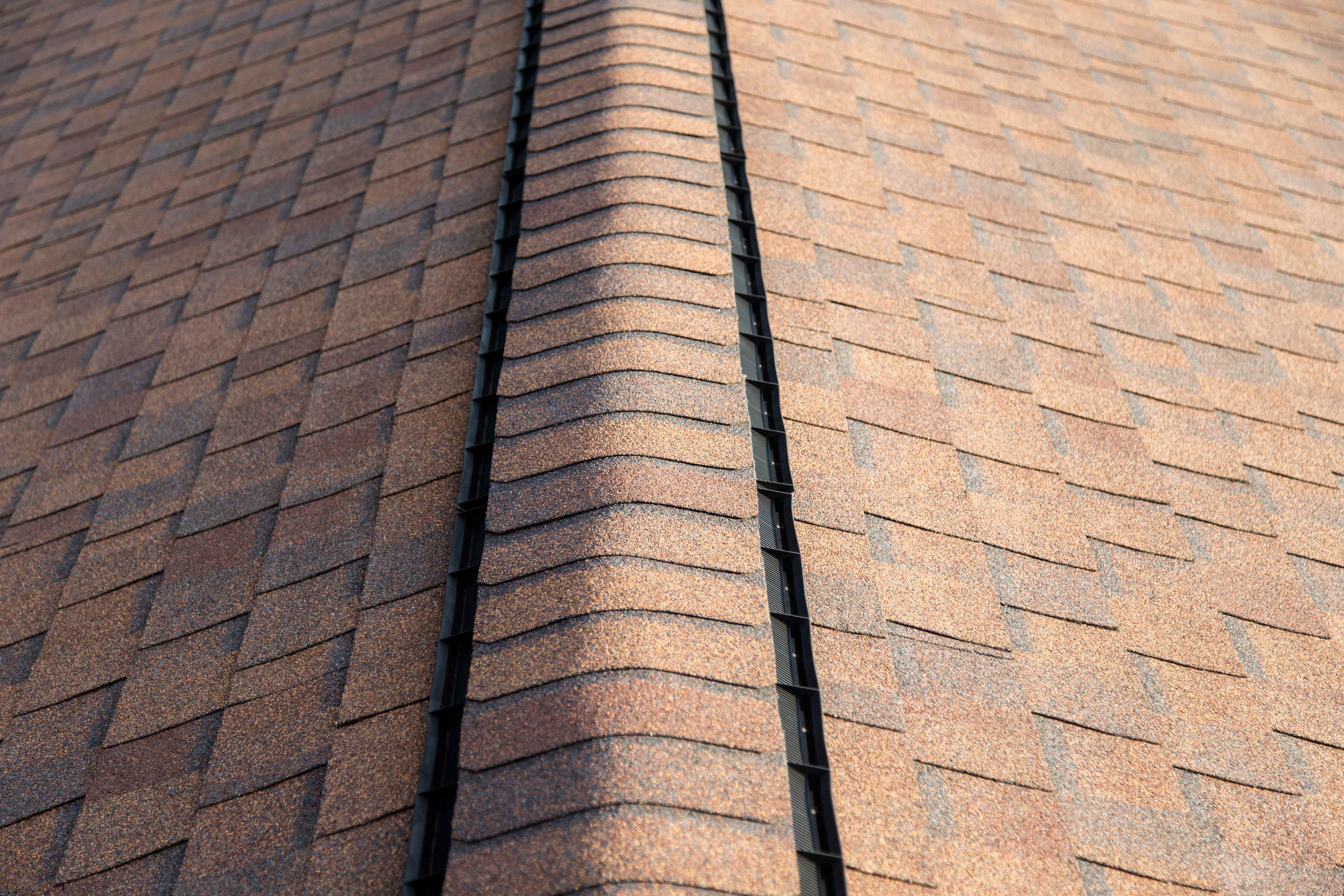 A roof ridge vent with cap on top of it
