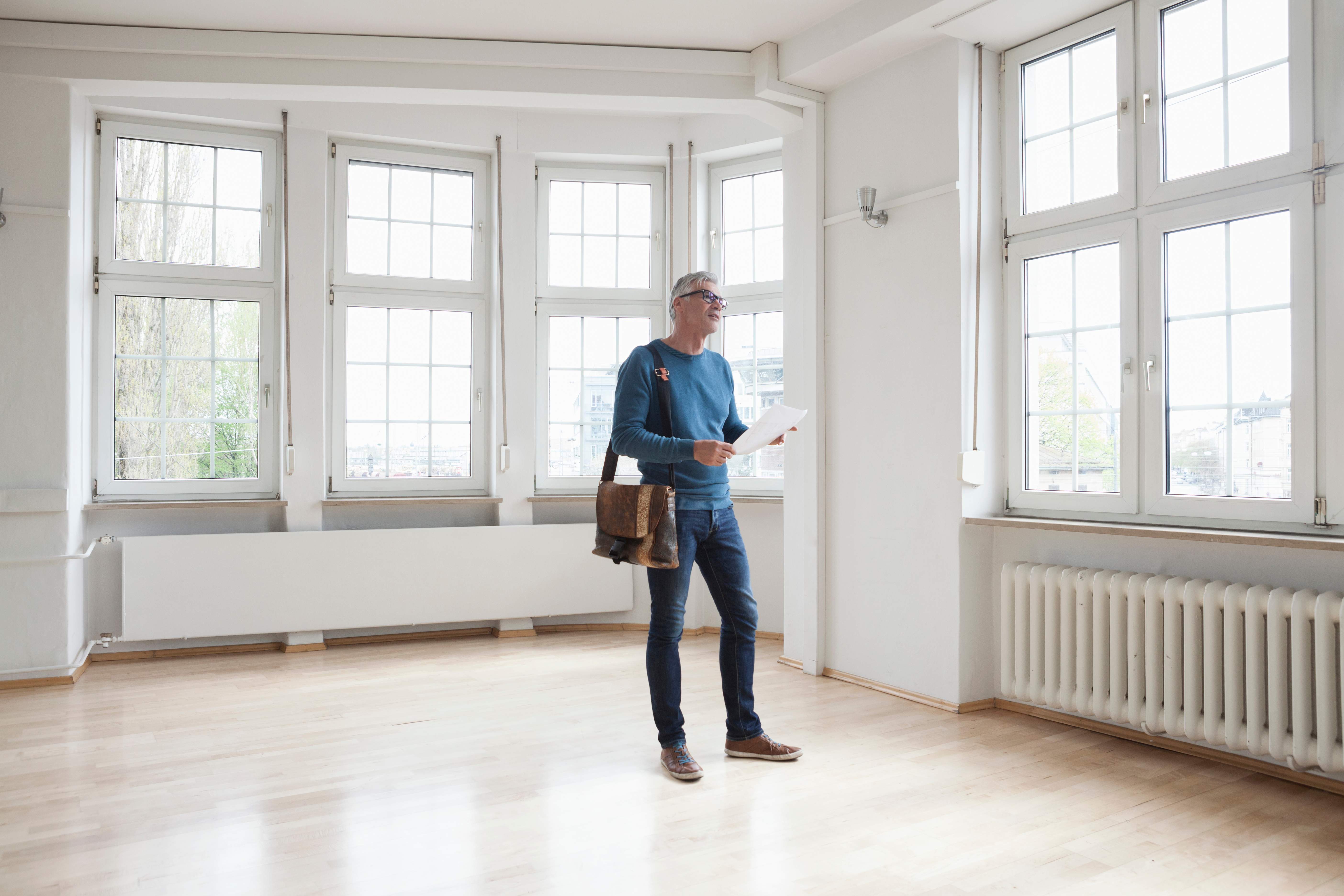 Man looking around in empty apartment