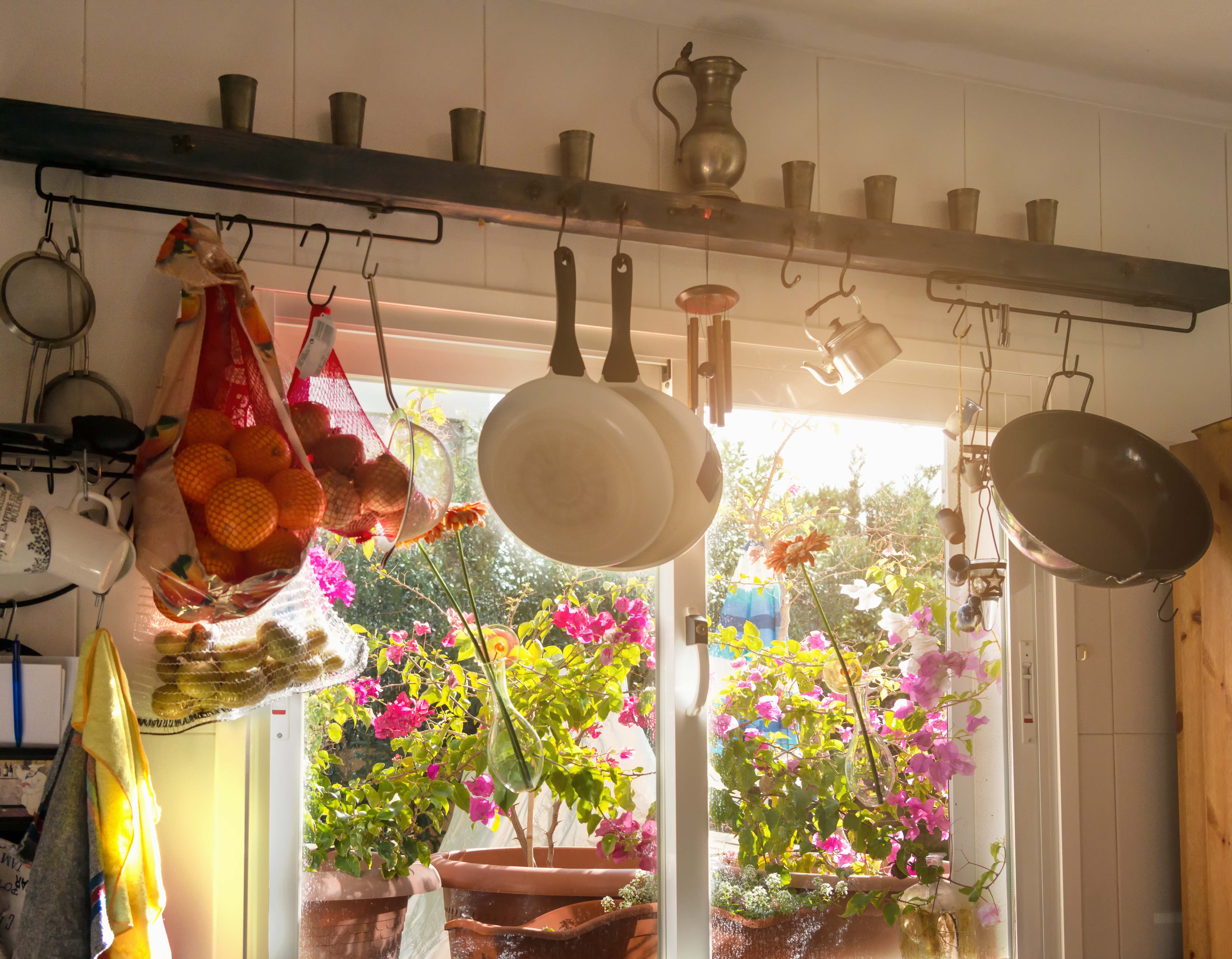 Hanging pots by the window in a small kitchen