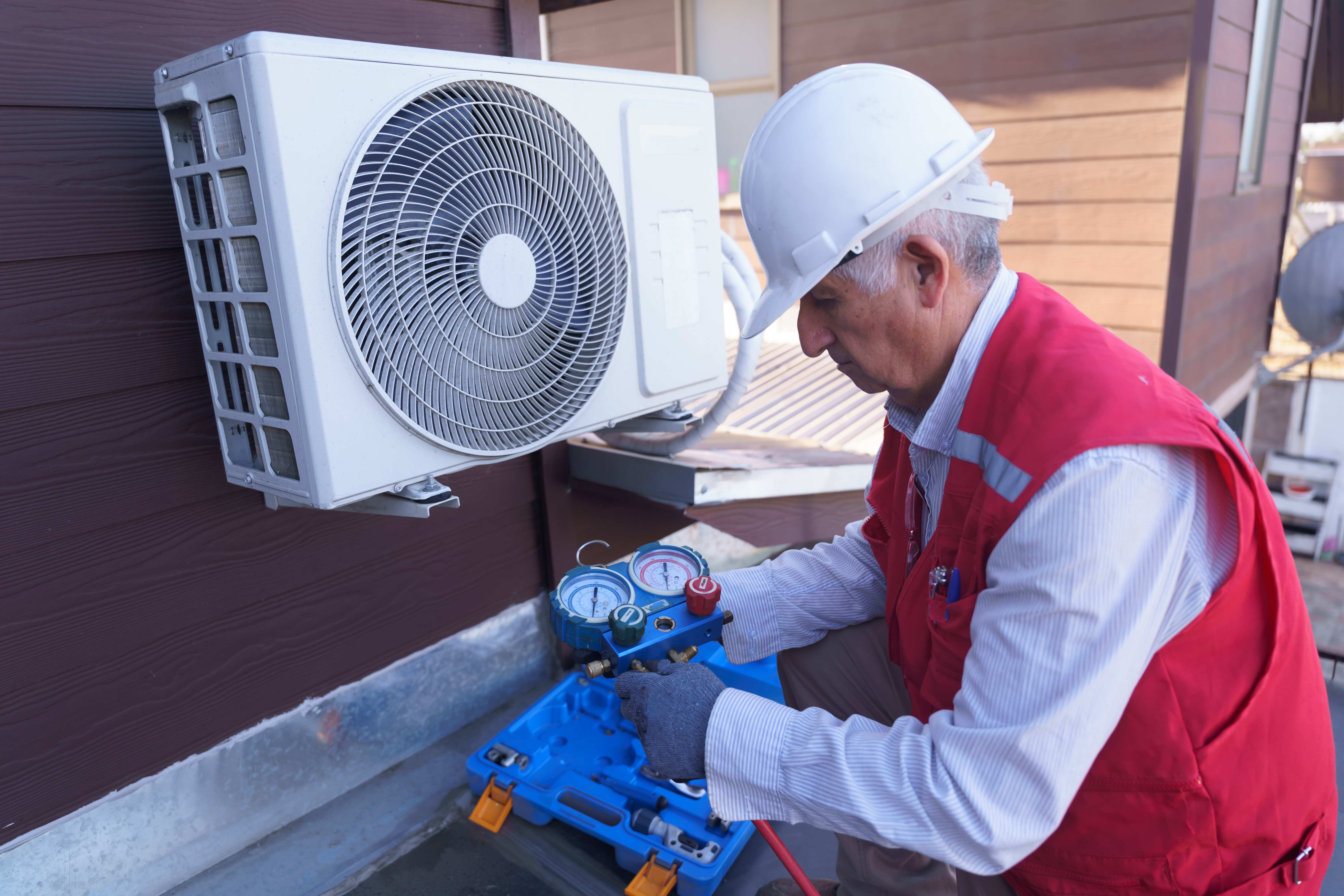 man performing maintenance check on mini split