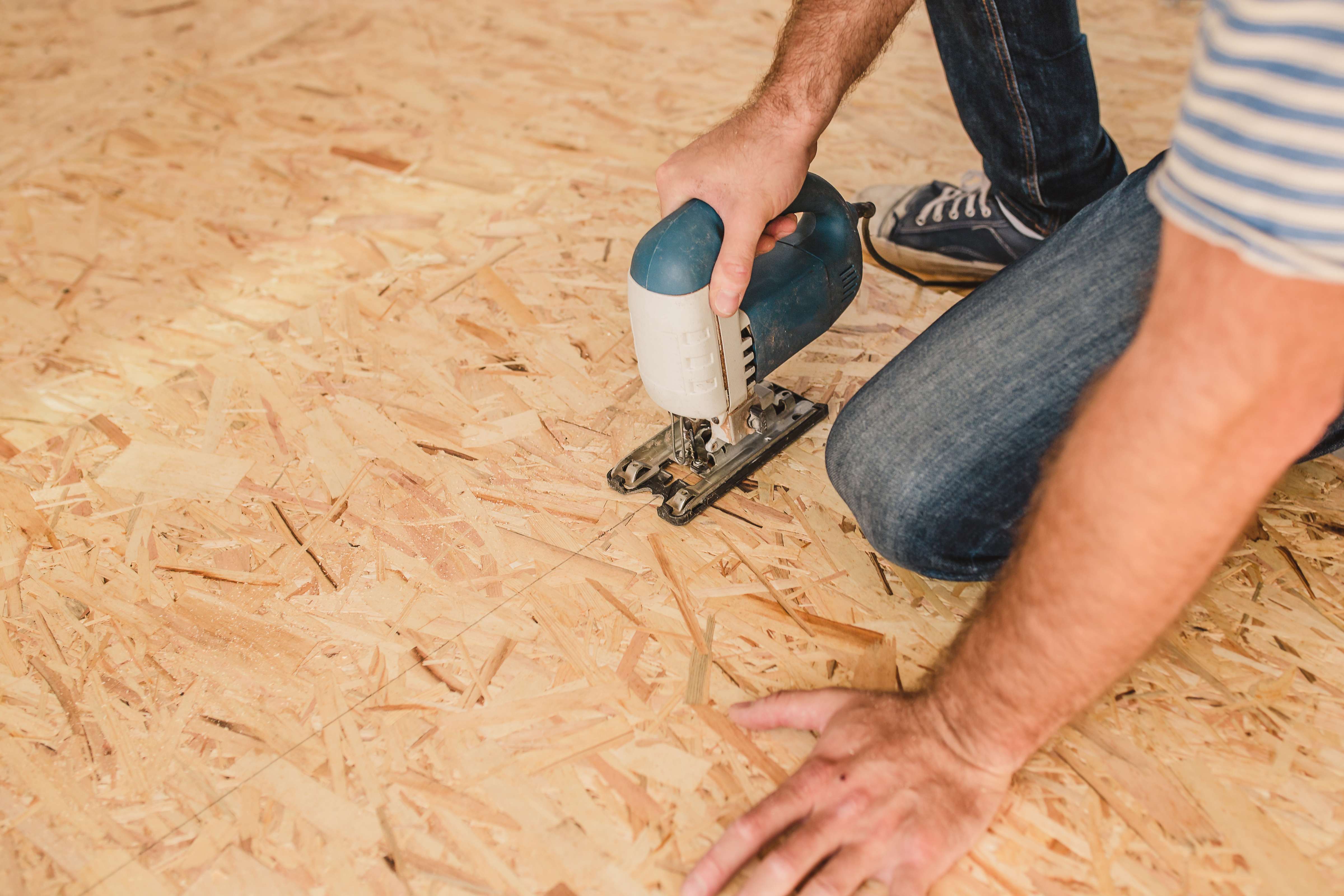 man installing subfloor