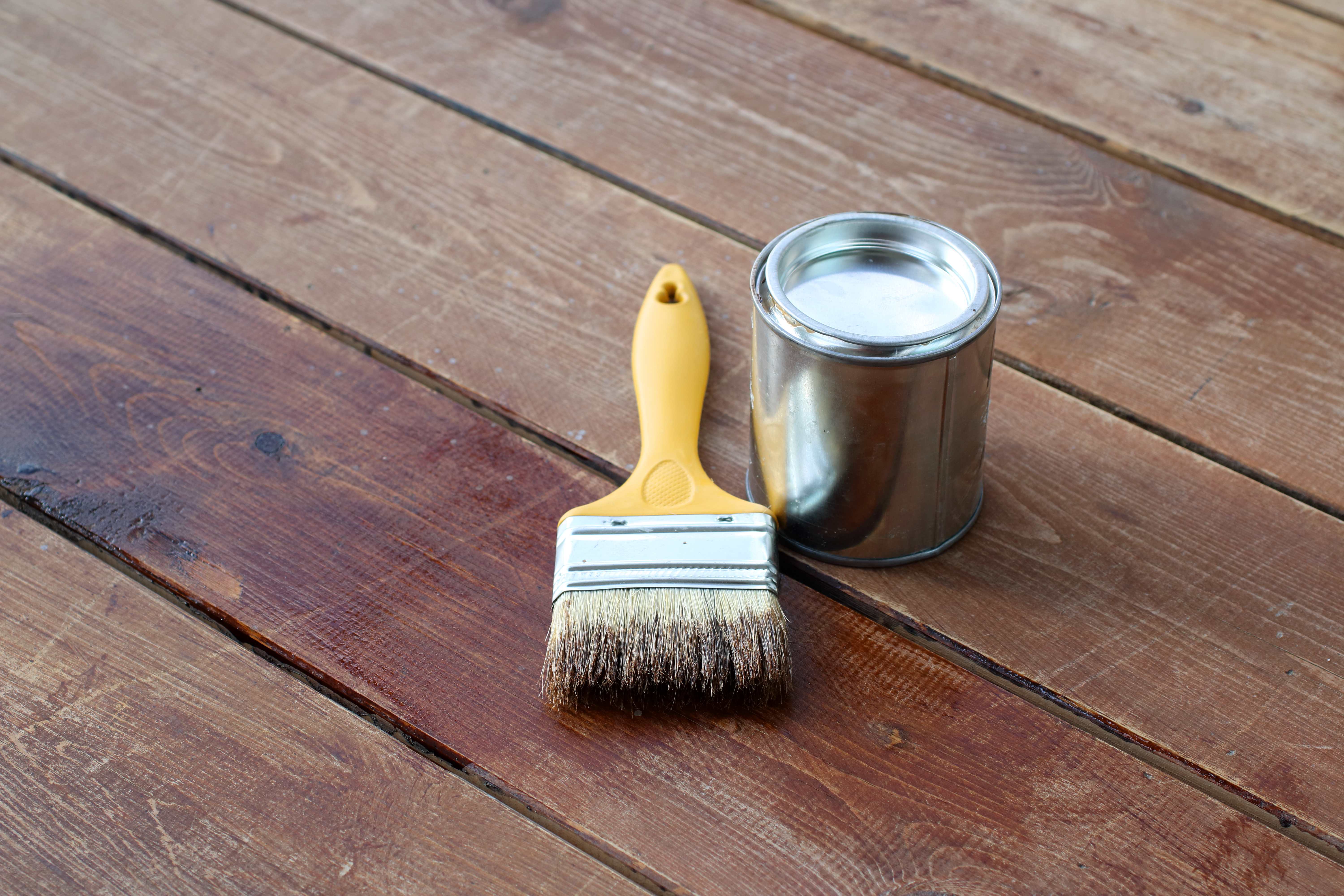 Paint brush and paint can and for a timber deck