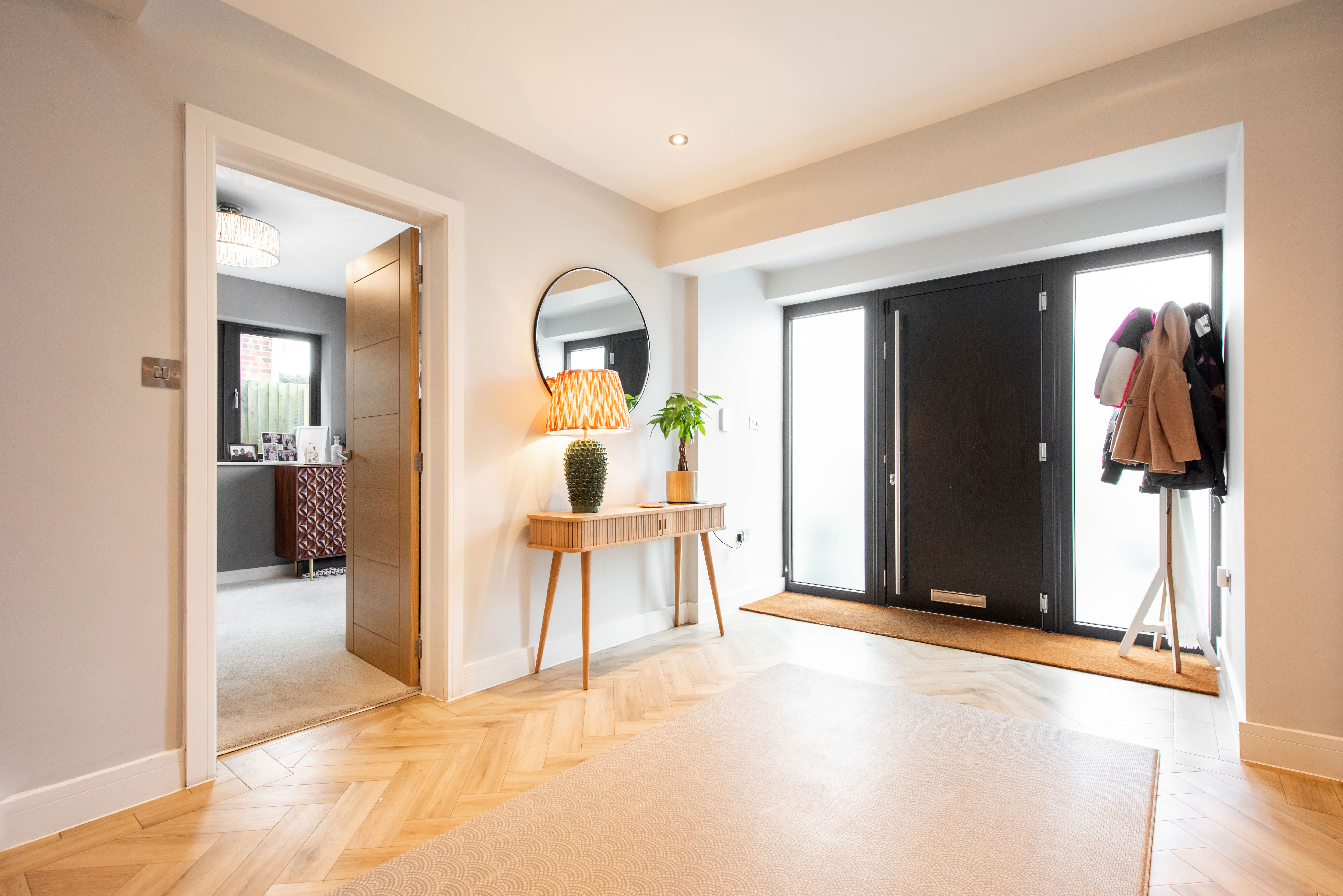 Large entryway with a coat rack and a console table