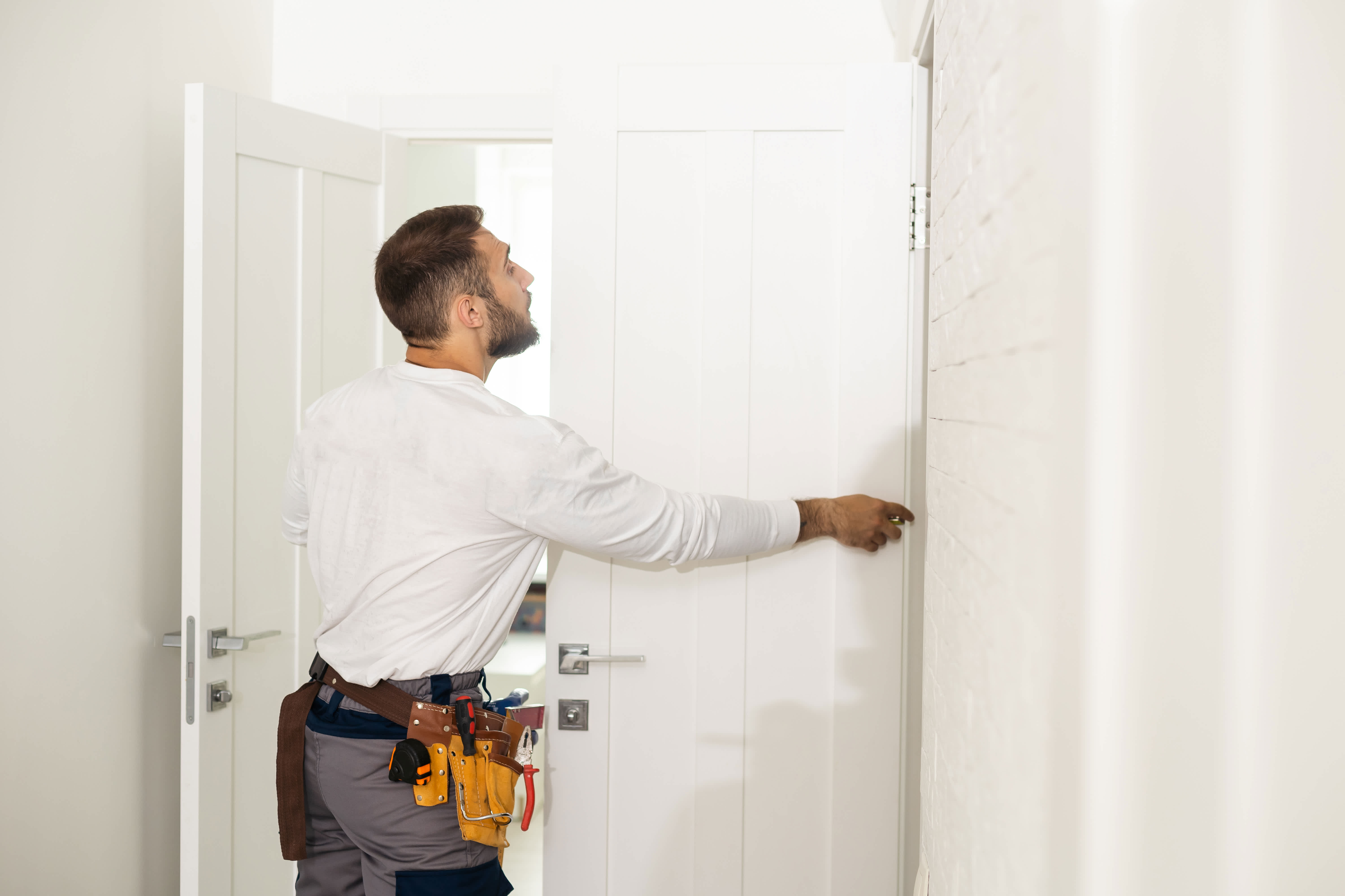 Contractor installs a white interior double door to a home bedroom