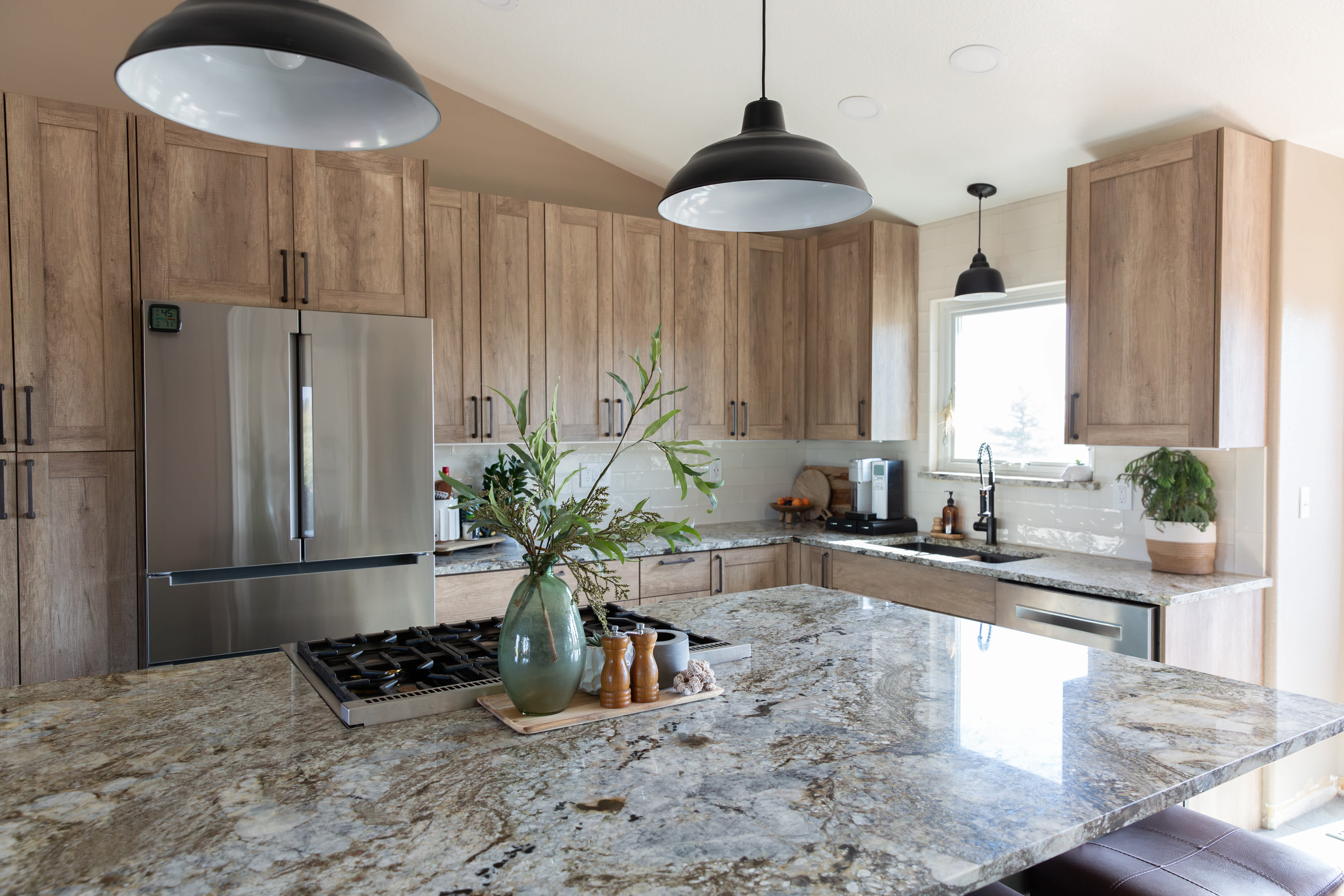 Modern kitchen with wood cabinets, granite countertops, and stainless steel appliances