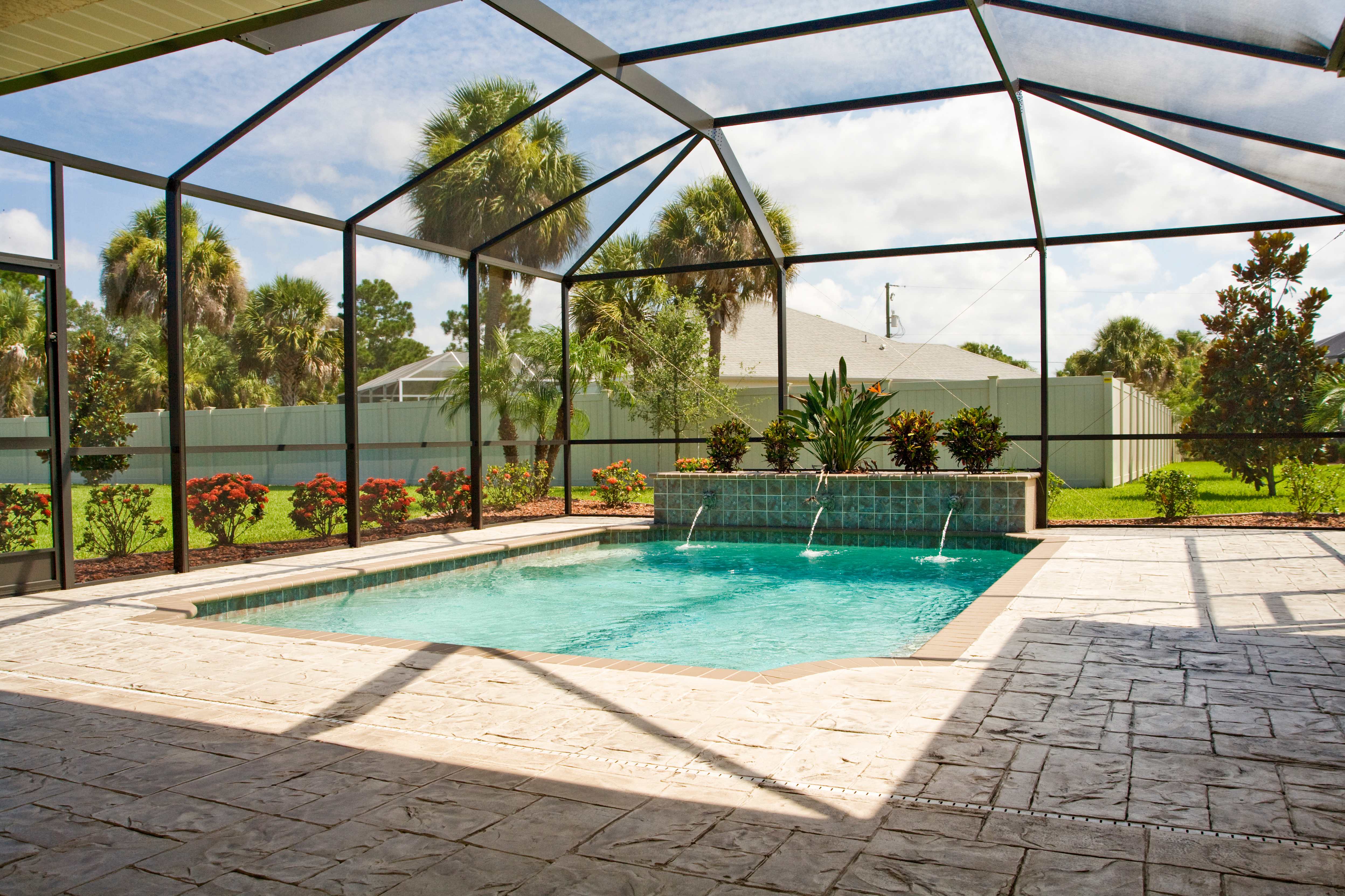 Lanai space with a swimming pool and stamped concrete flooring