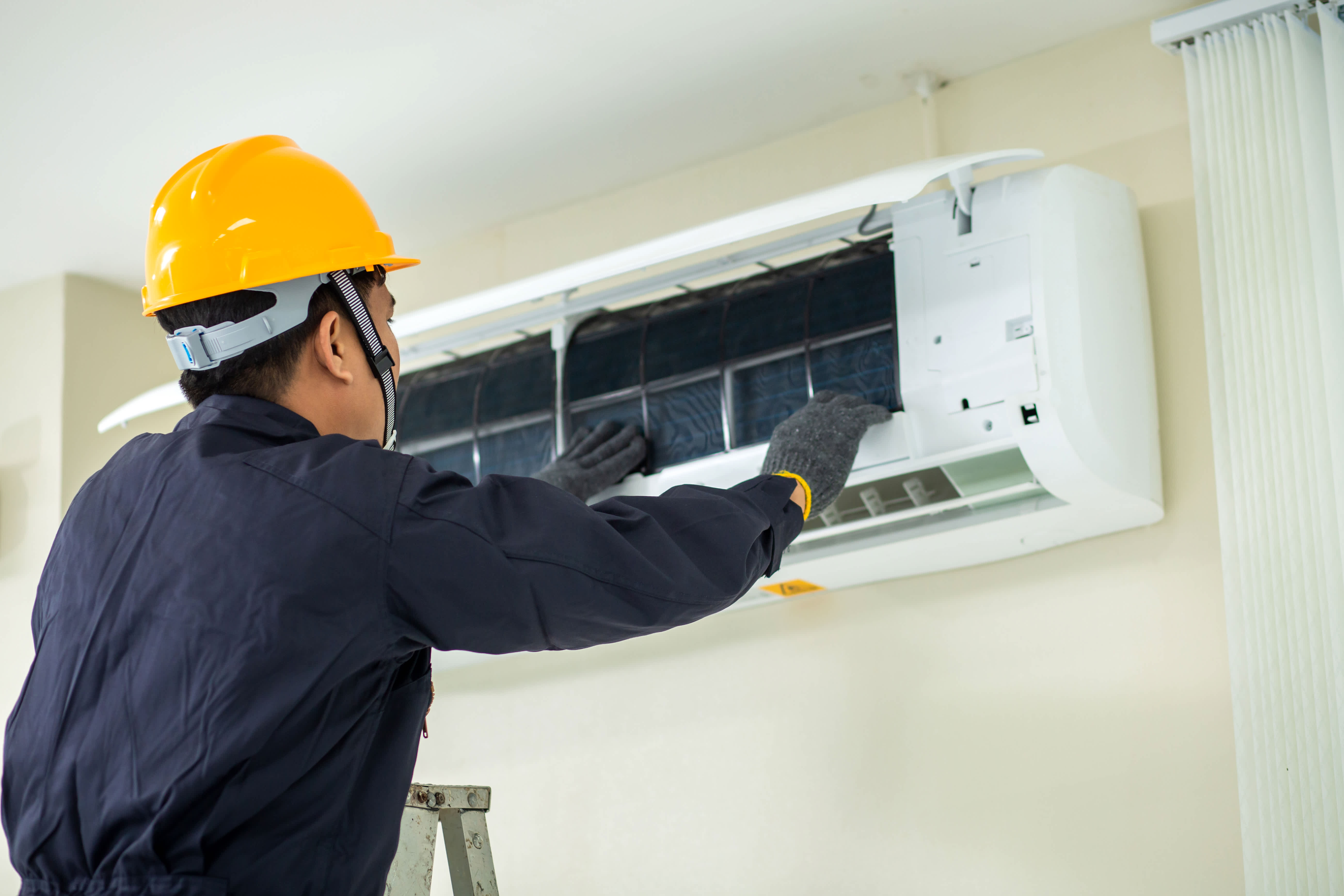 Technician repairing air conditioner