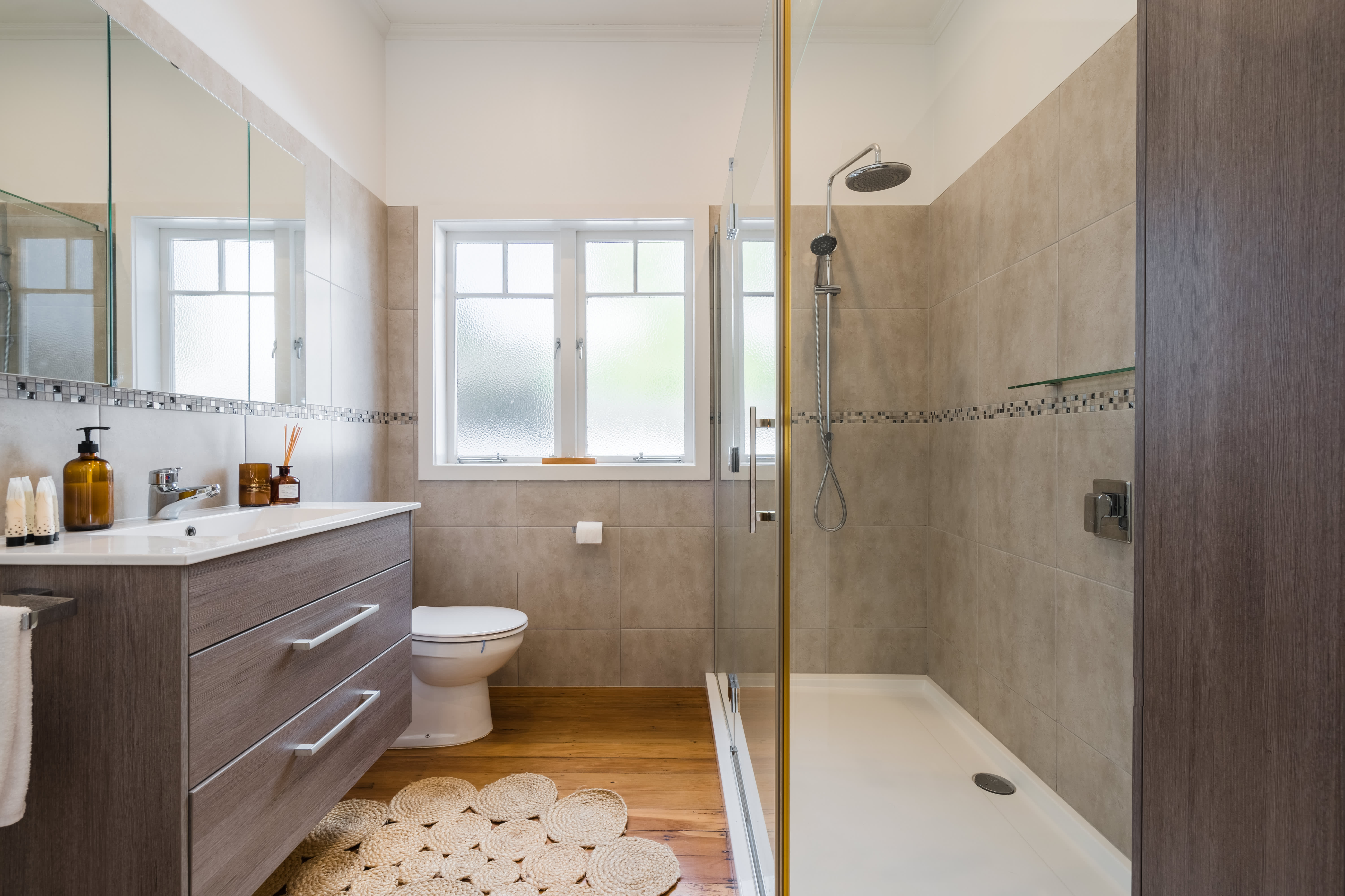 Clean bathroom with a window and a walk-in shower