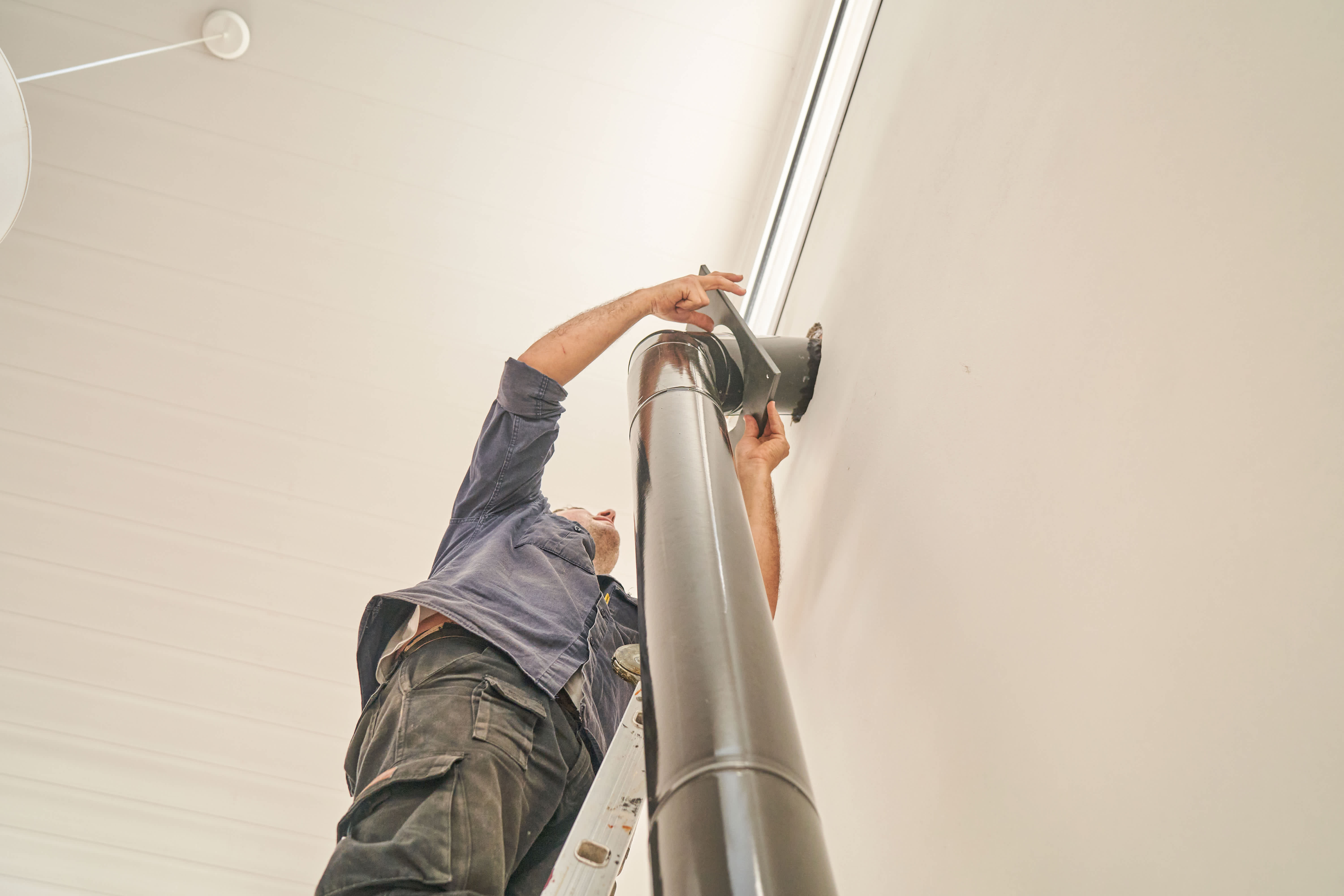 A technician installing ductwork