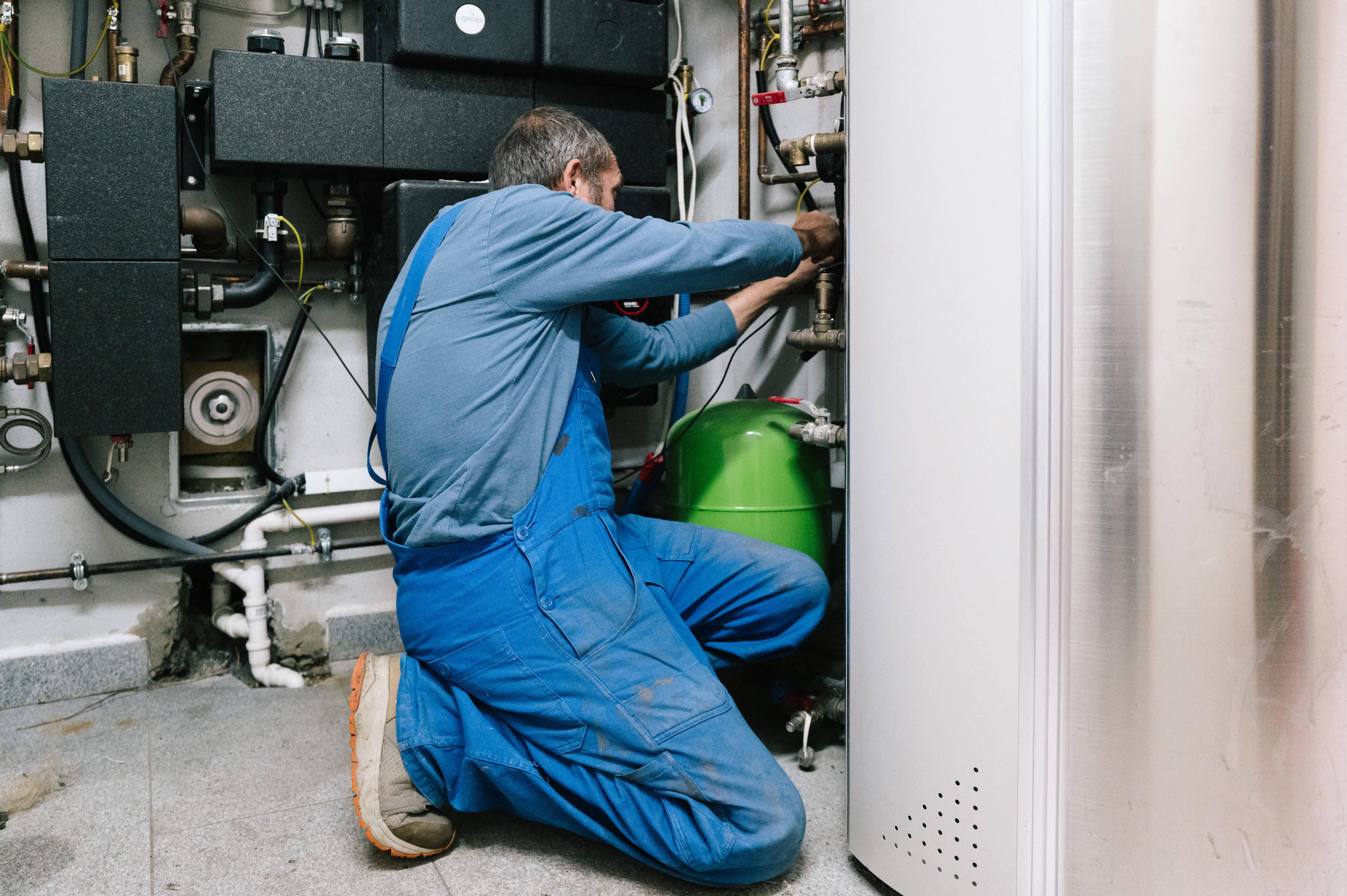 A technician inspecting a water heater