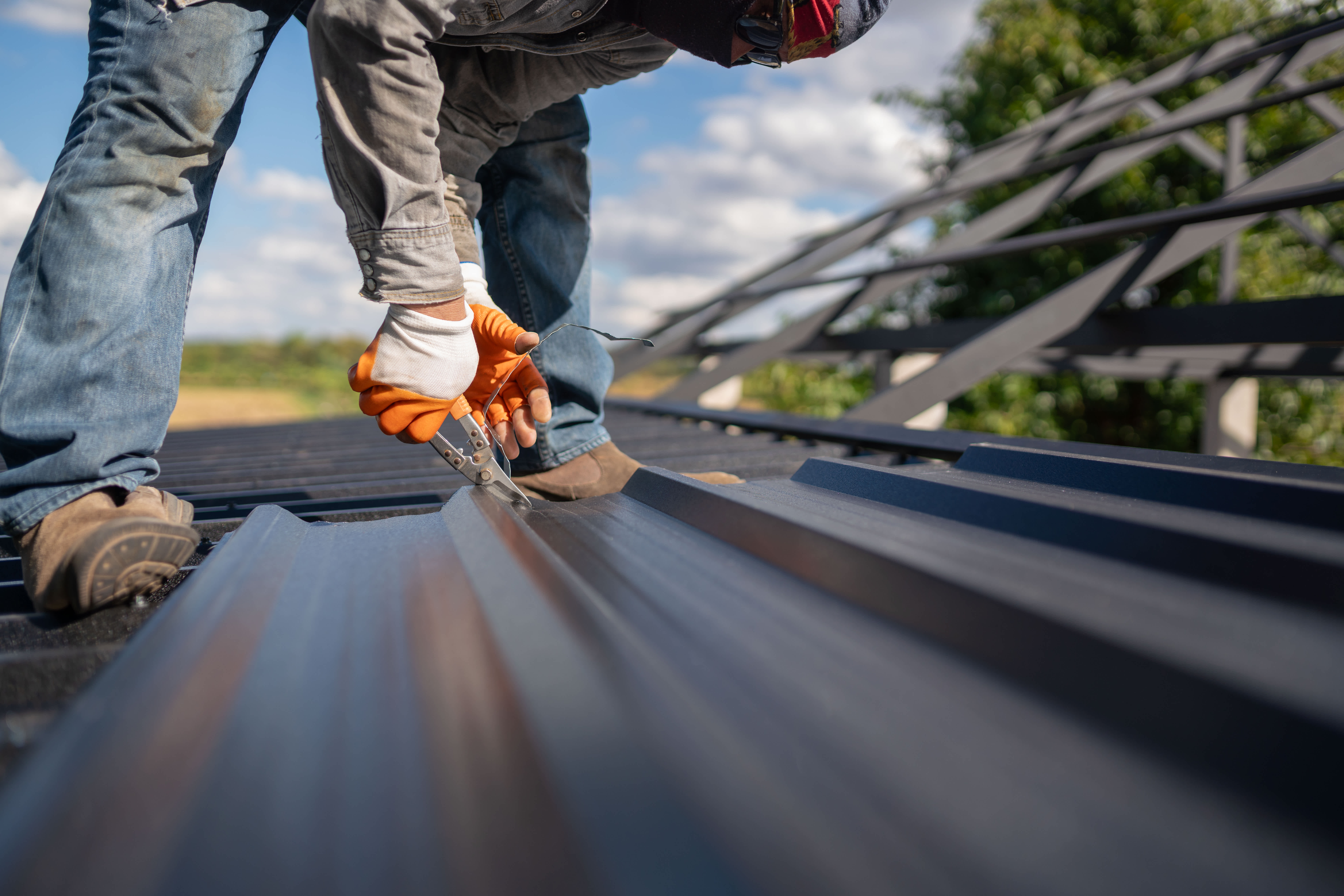 A person installing a metal roof