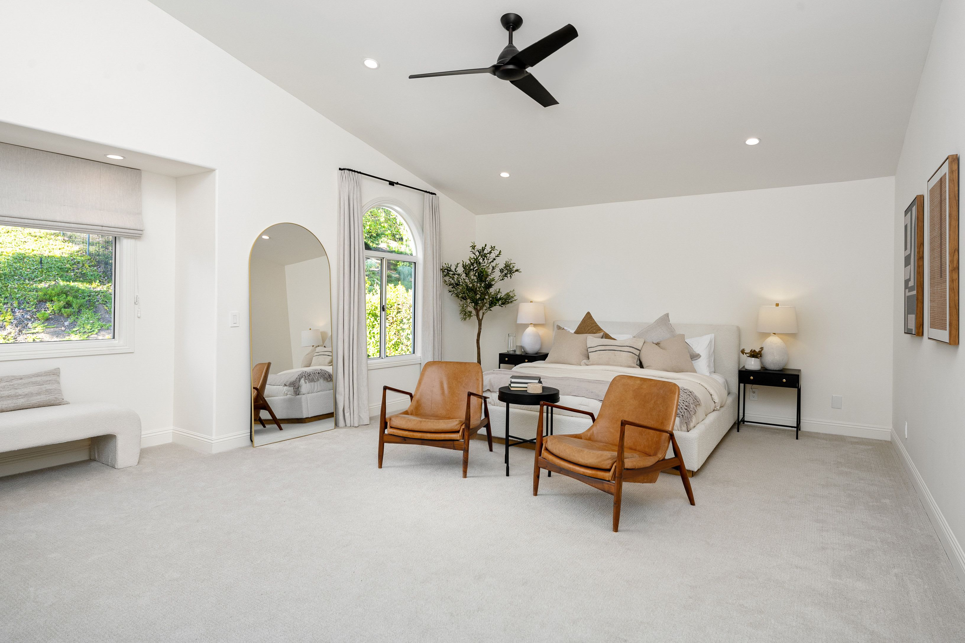 A bedroom with a wall-to-wall carpet