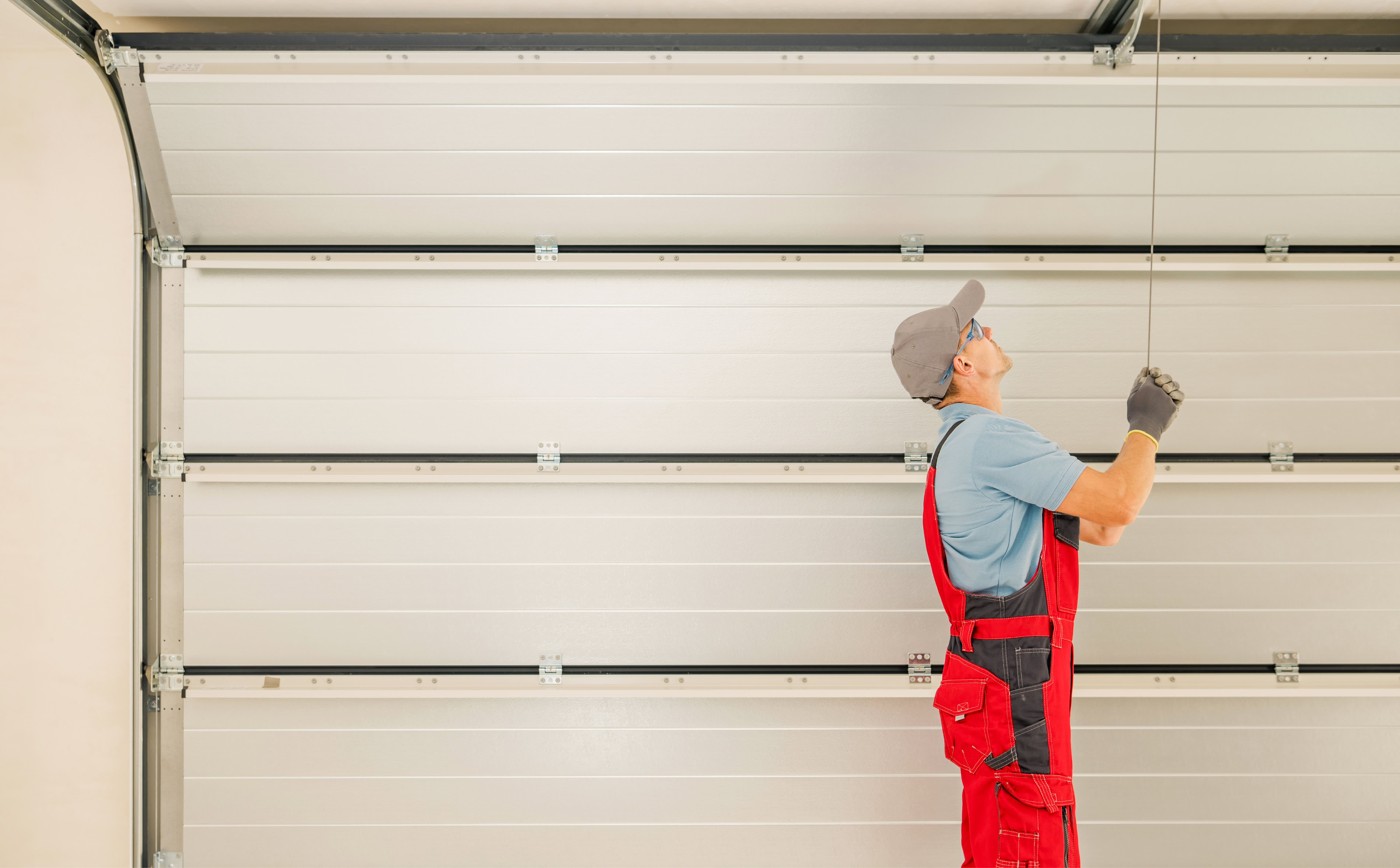 A professional installing a new garage door