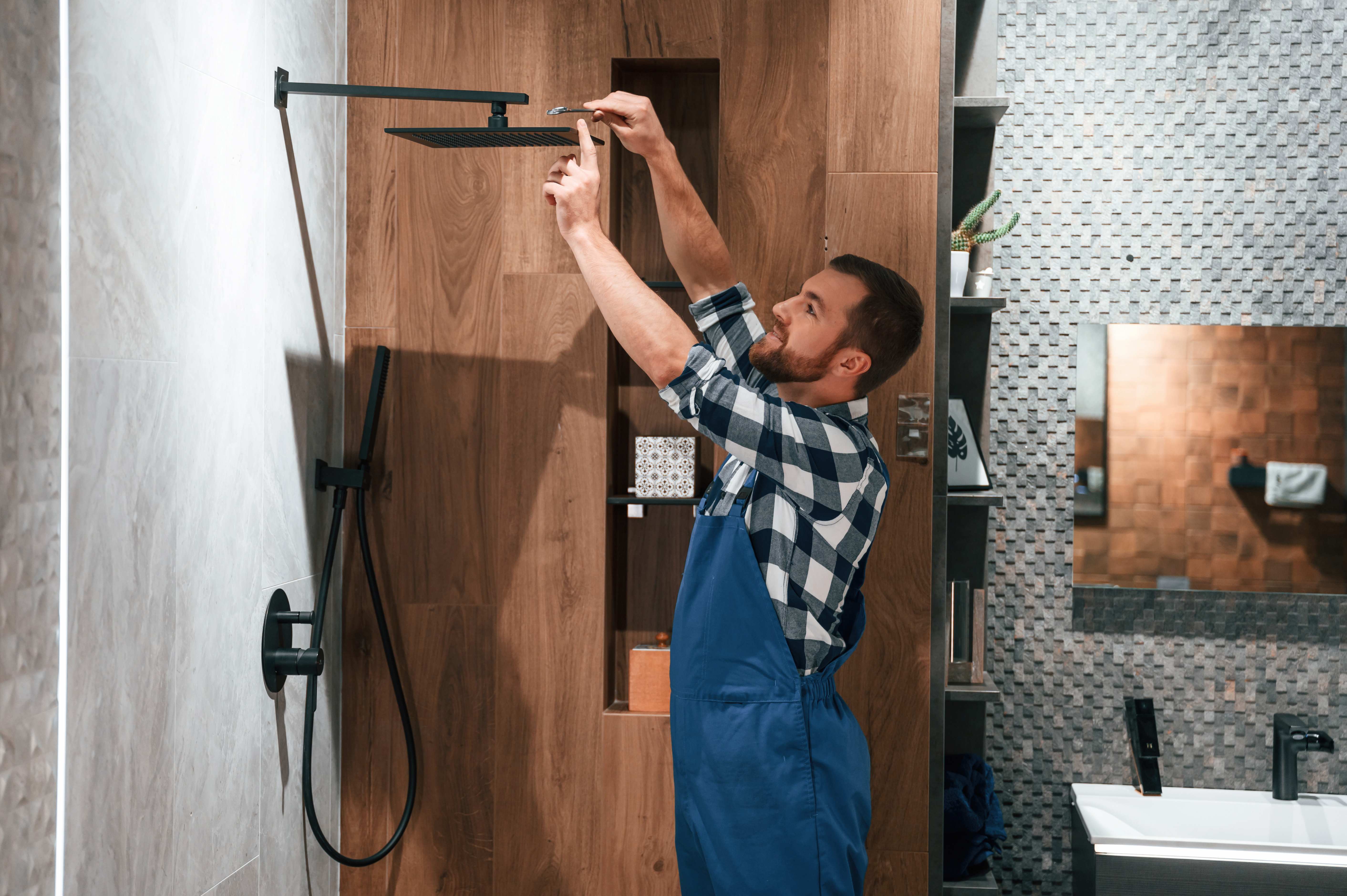 A professional installing a shower head