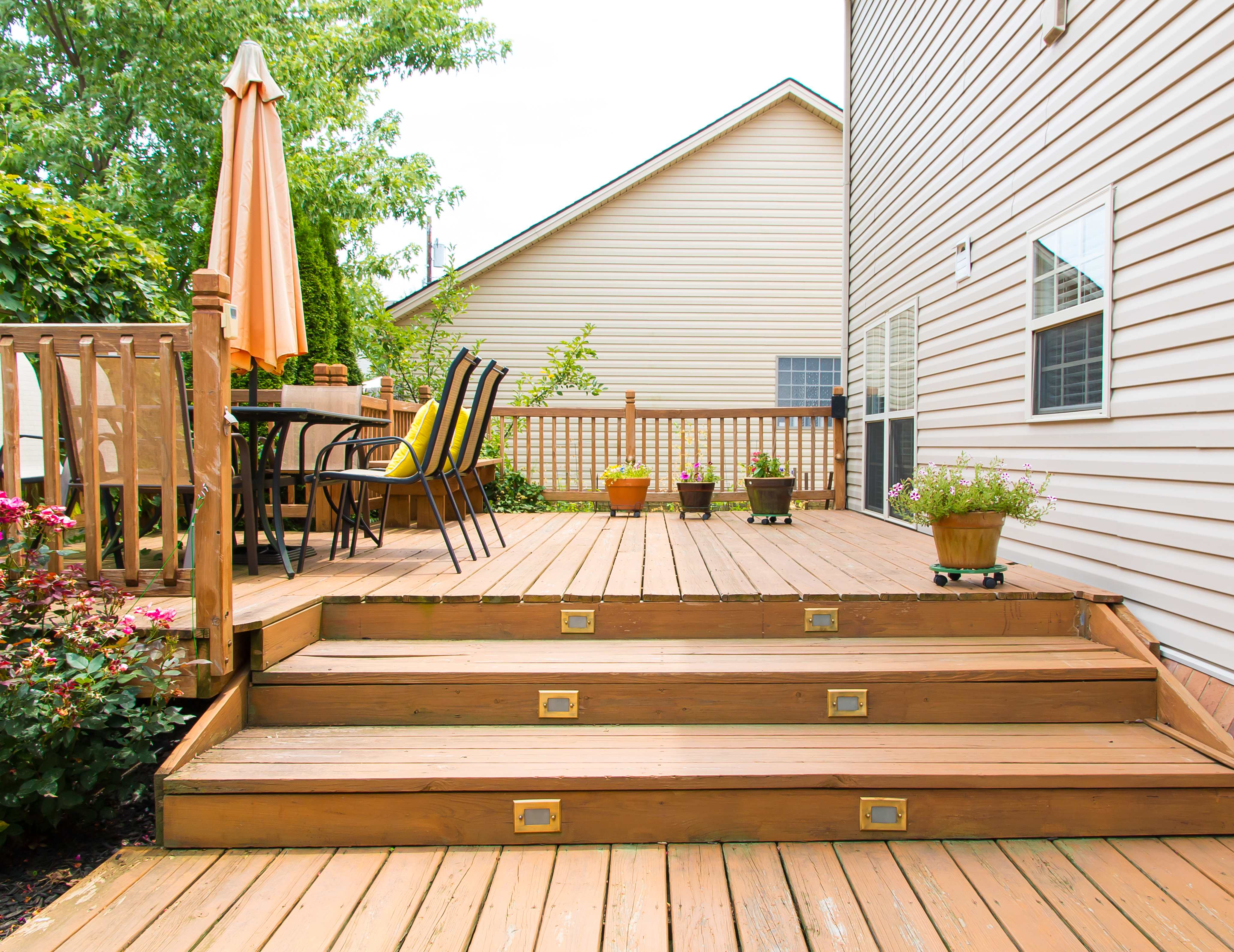 A wooden deck with outdoor furniture