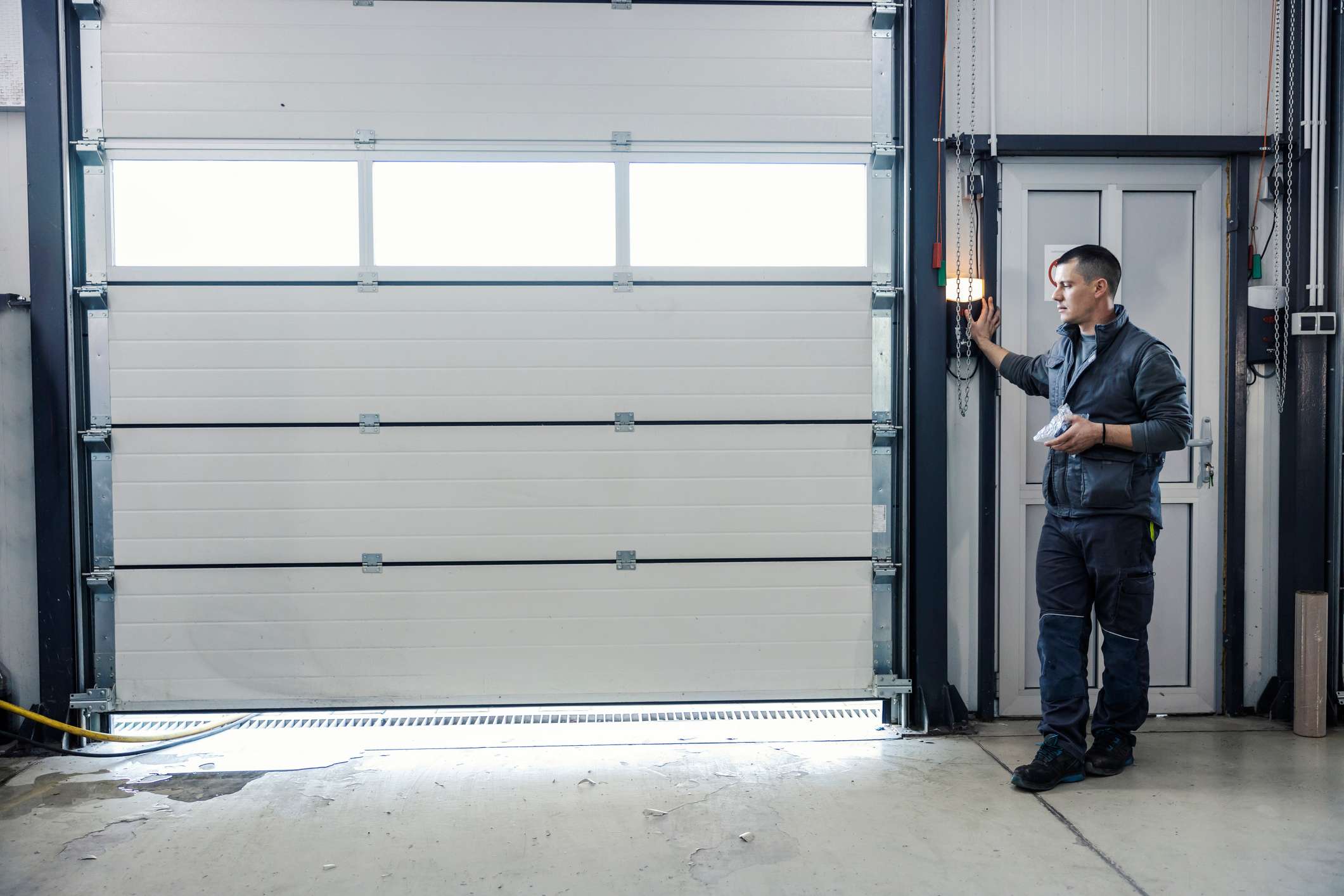 A mechanic opening the garage door