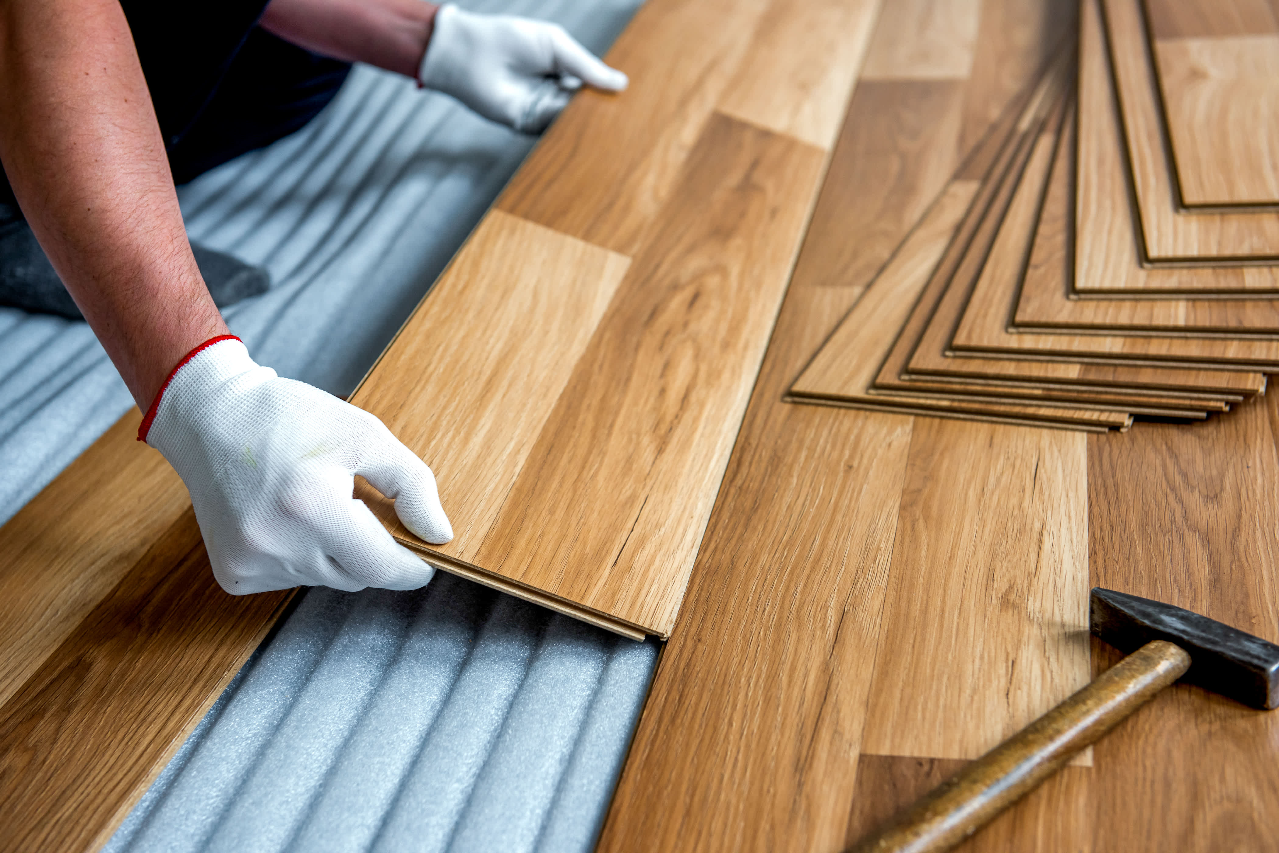 A builder laying laminate flooring