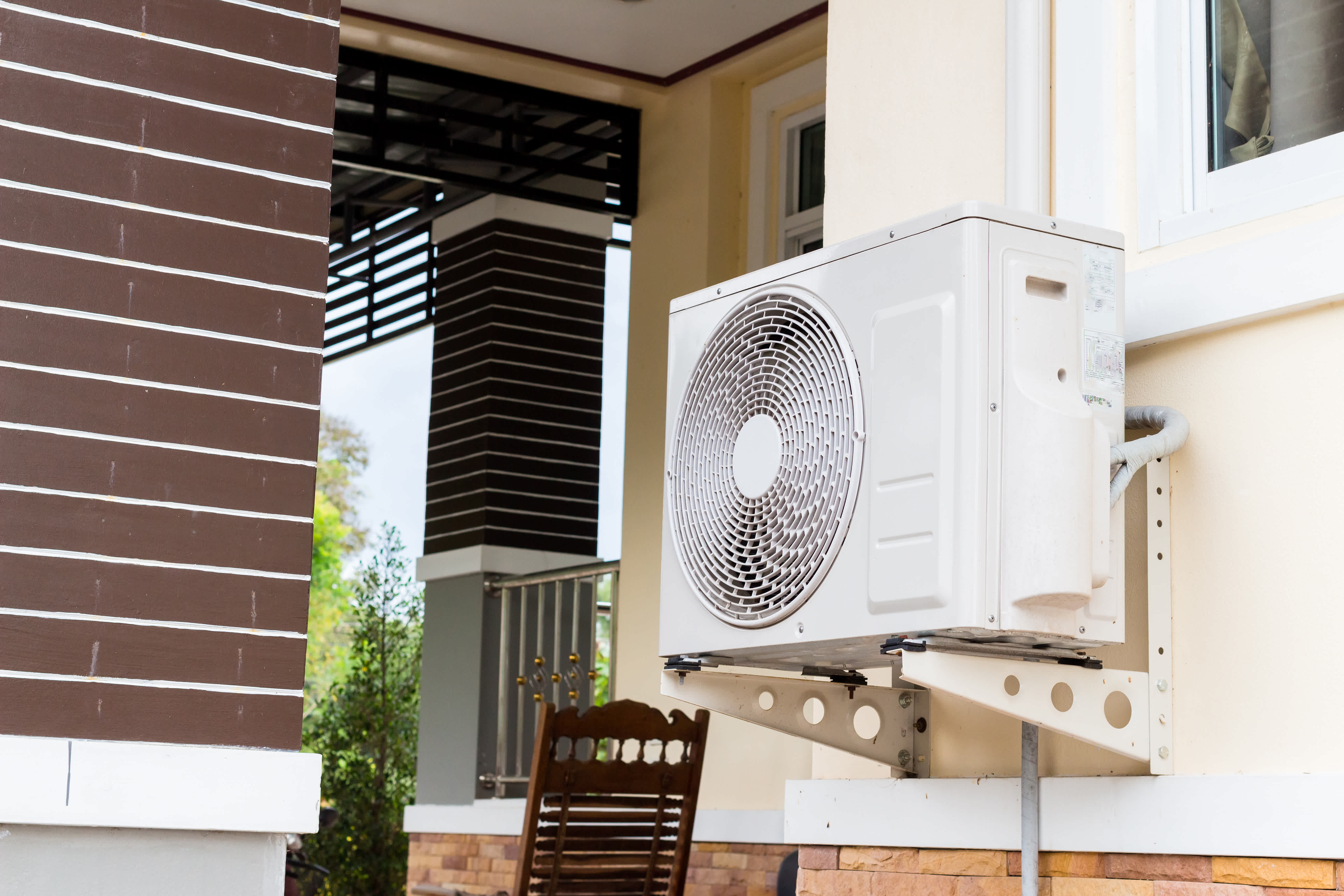 An air conditioning unit is mounted on the wall