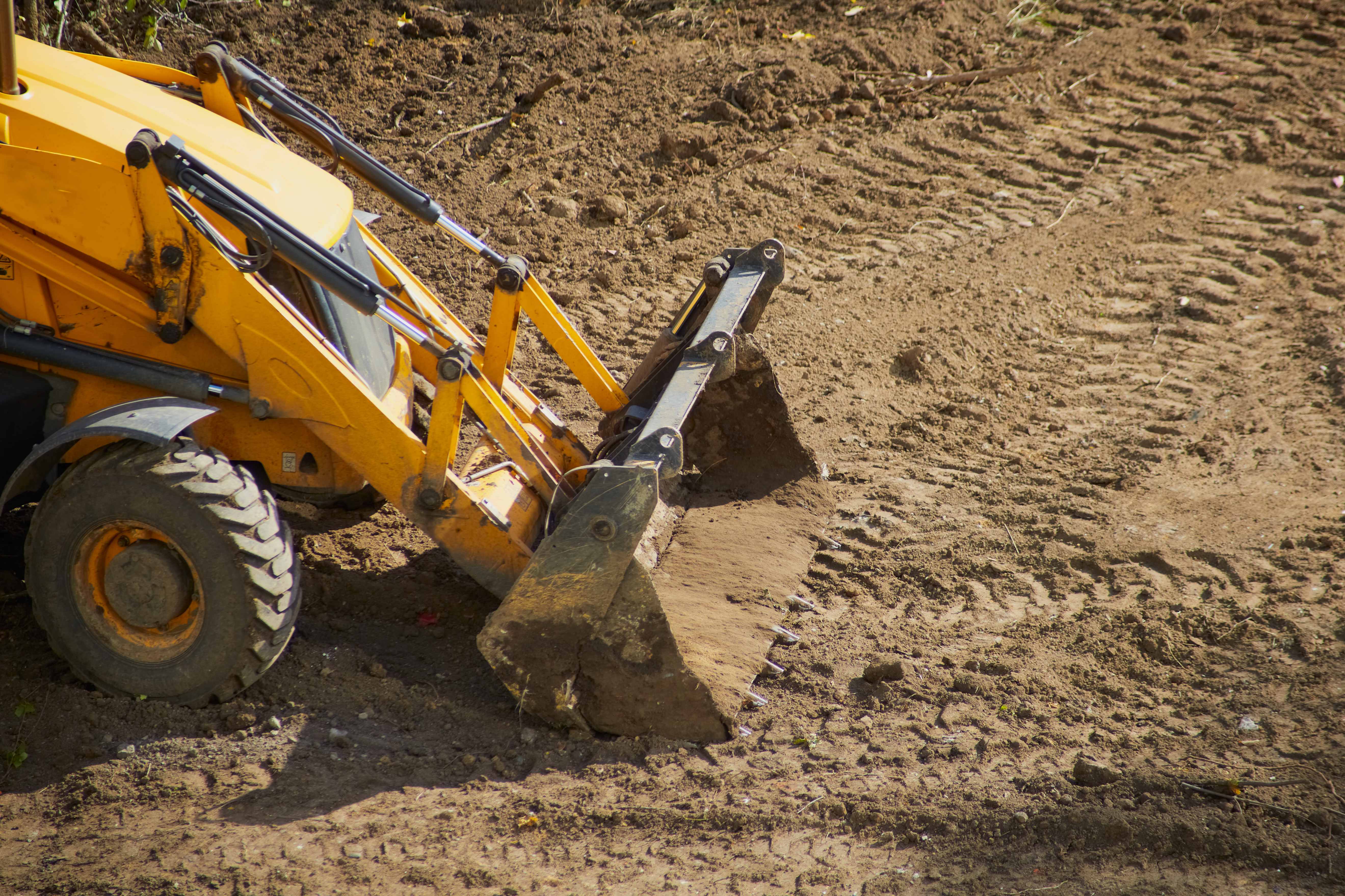 Yellow bulldozer with bucket on construction site