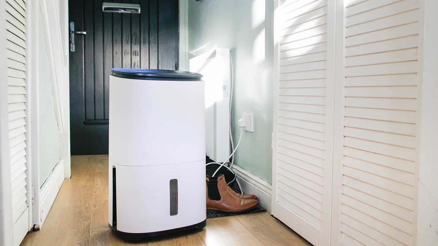 Portable dehumidifier sitting in the hallway of a house