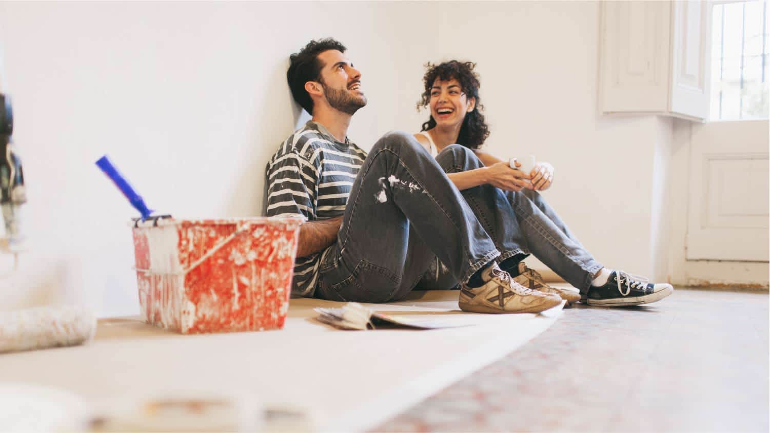 Young couple painting walls