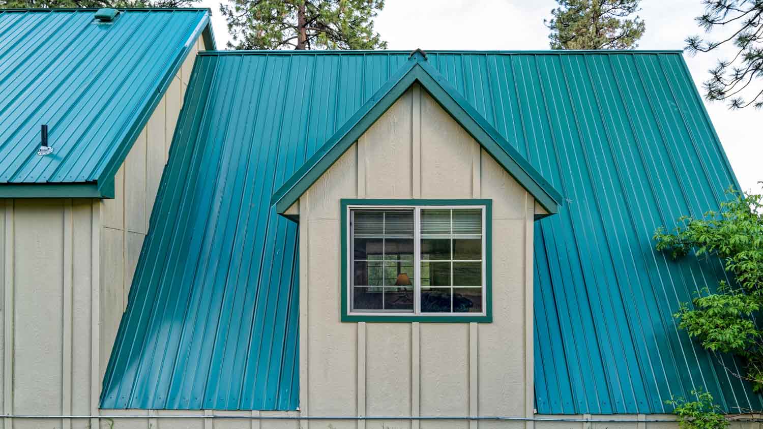 house with blue metal seam roof