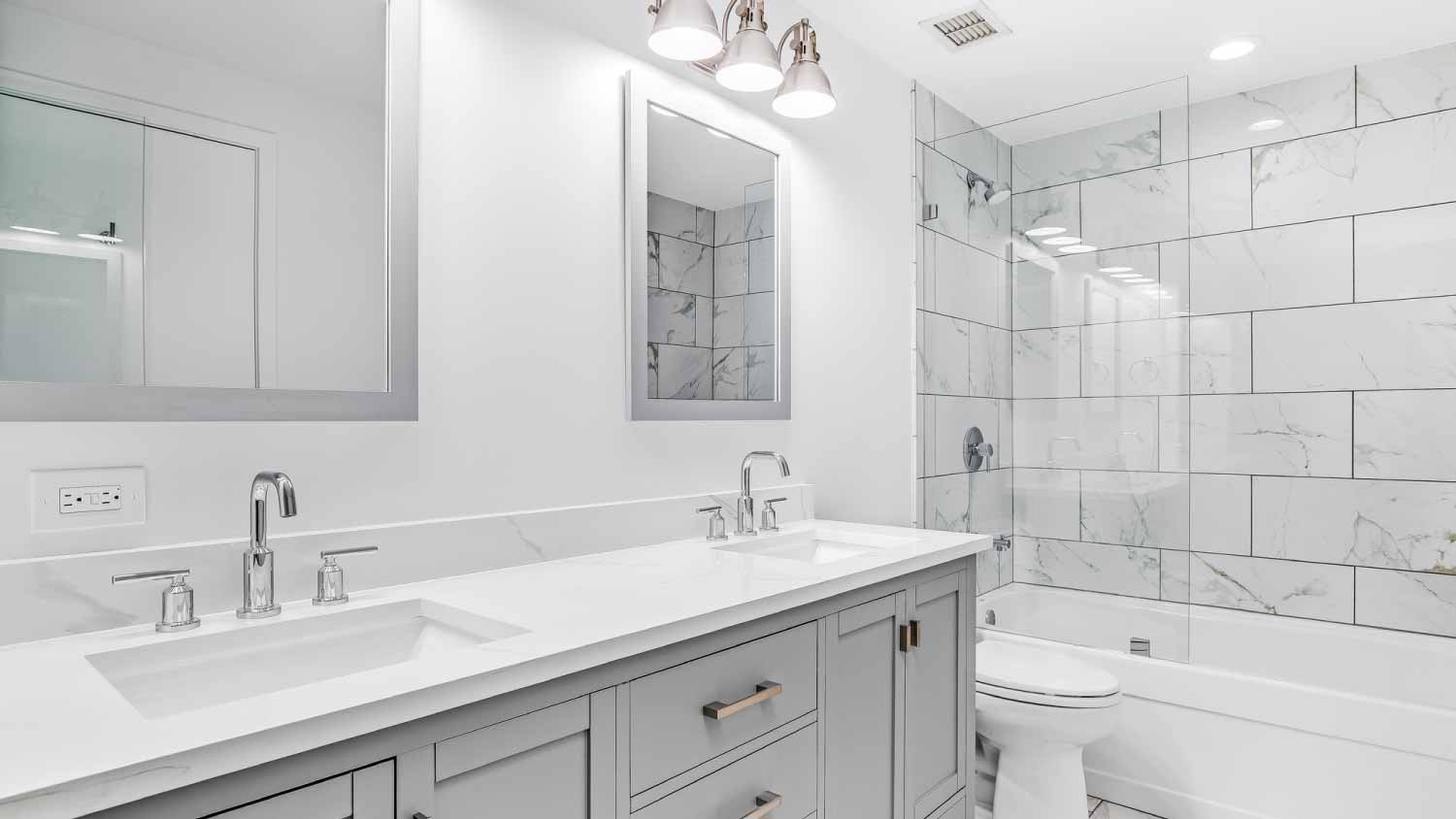 Bathroom with a grey cabinet and tiled shower