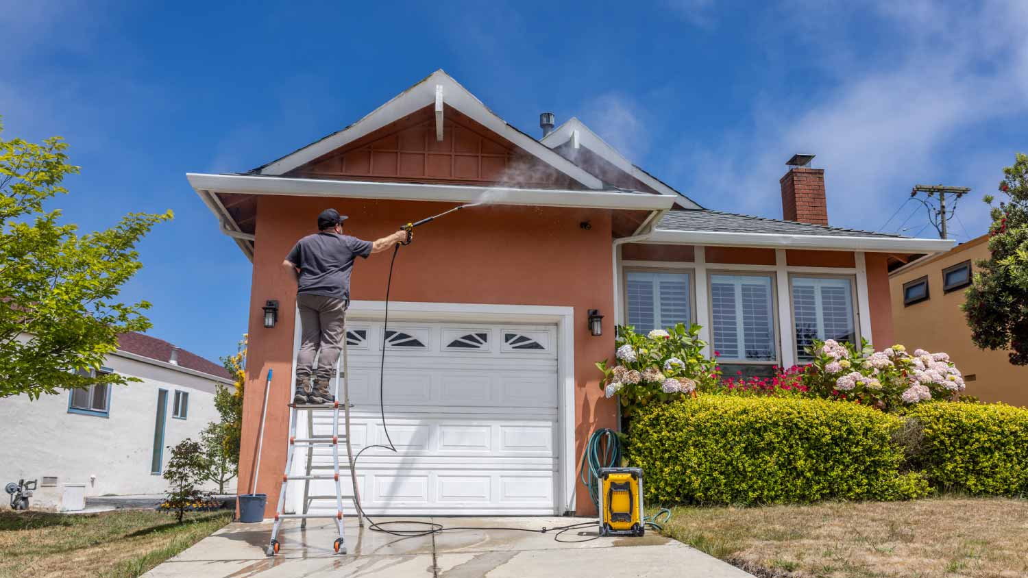 Washing facade house with pressure washer