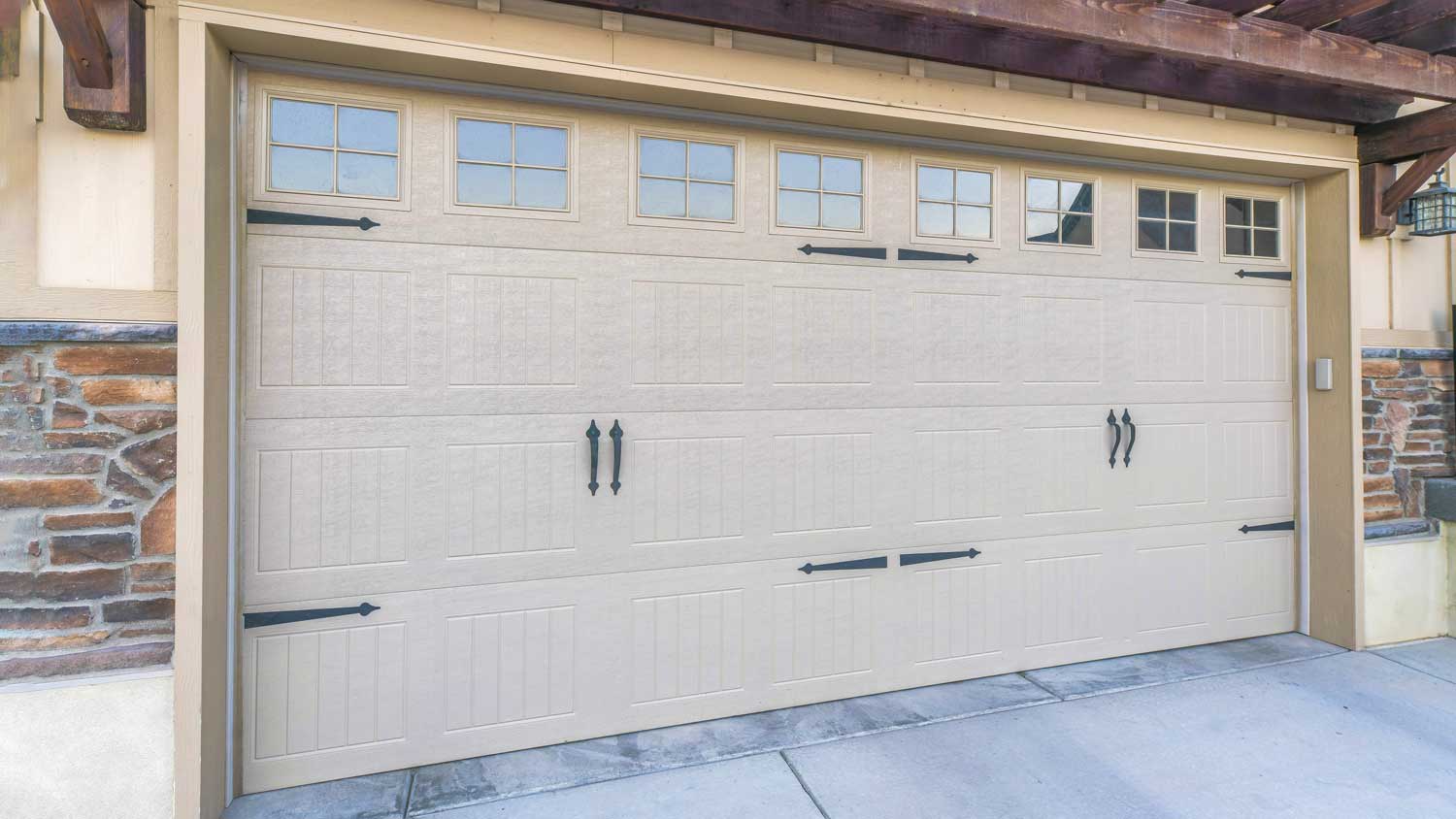 Duplex homes with beige garage doors, including different tones of beige paint