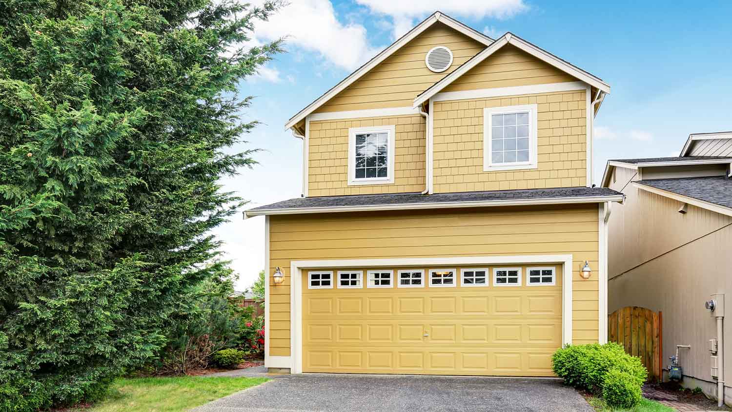 Yellow suburban house with yellow garage door