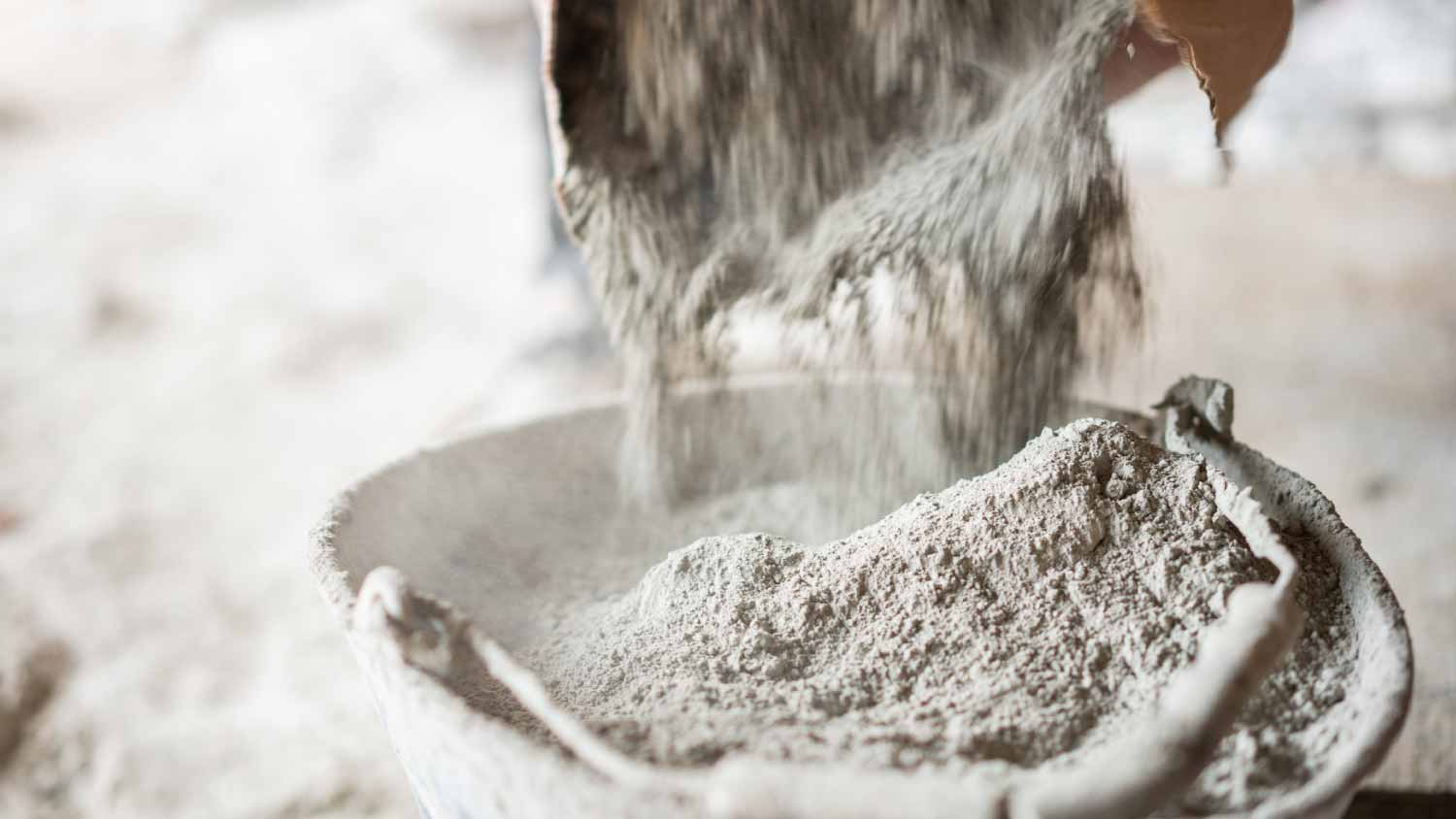 Filling a bucket with cement at construction site