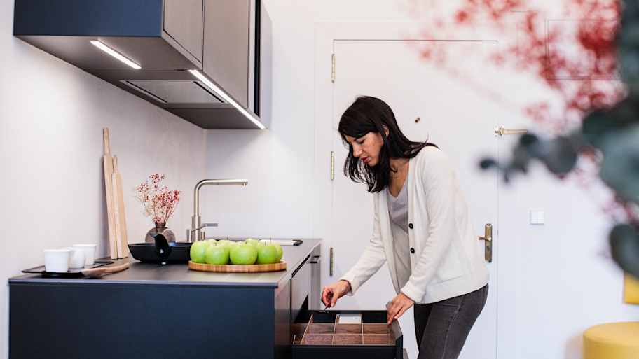 Woman opening kitchen drawer