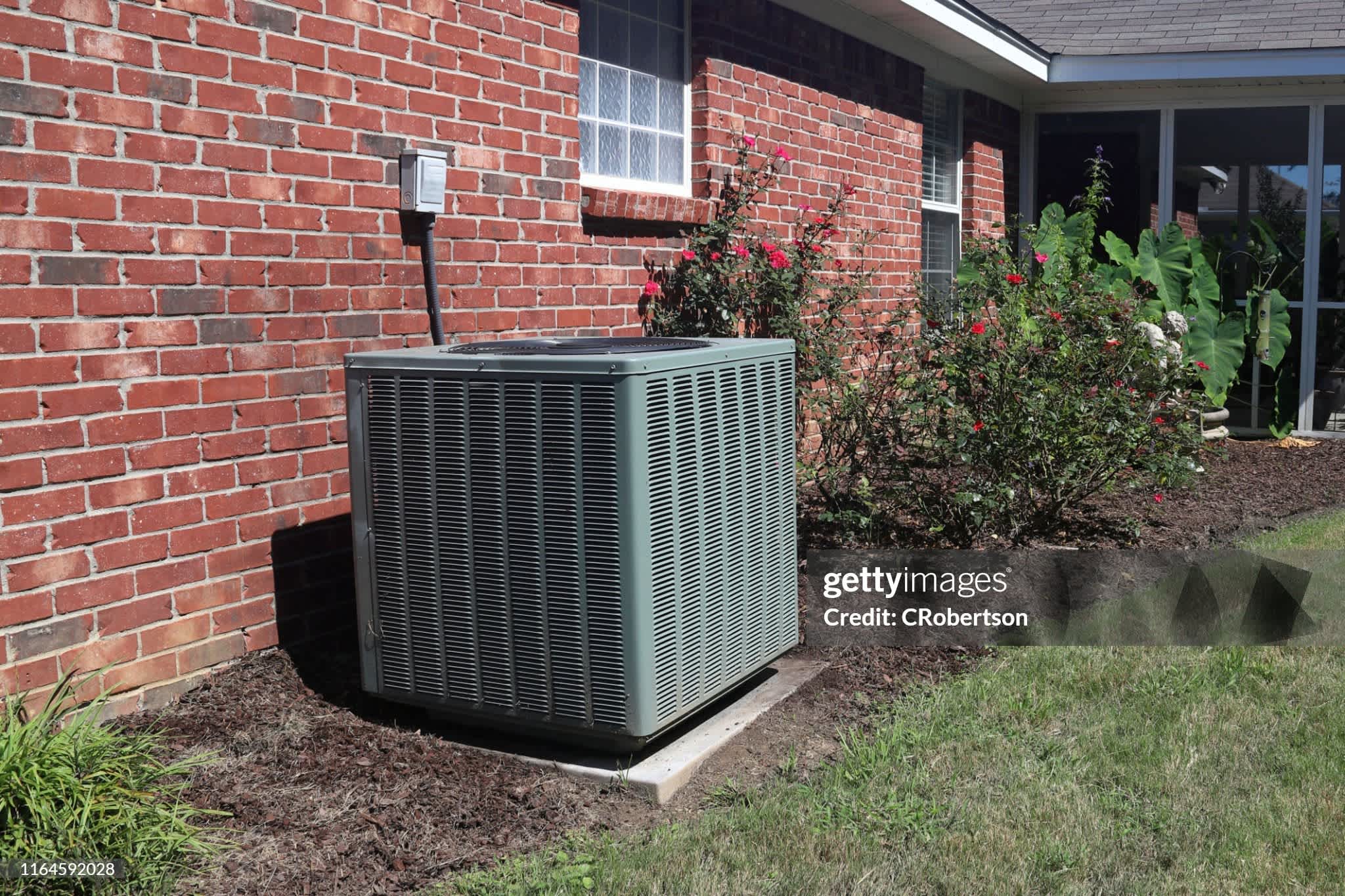 A HVAC system installed in the backyard of a house