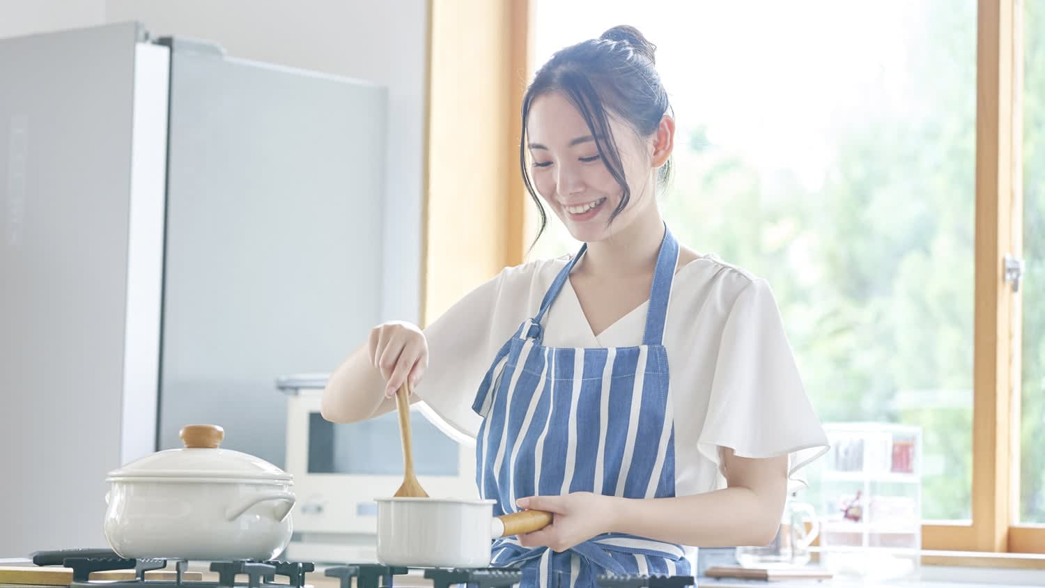 A woman cooking on a gas stove